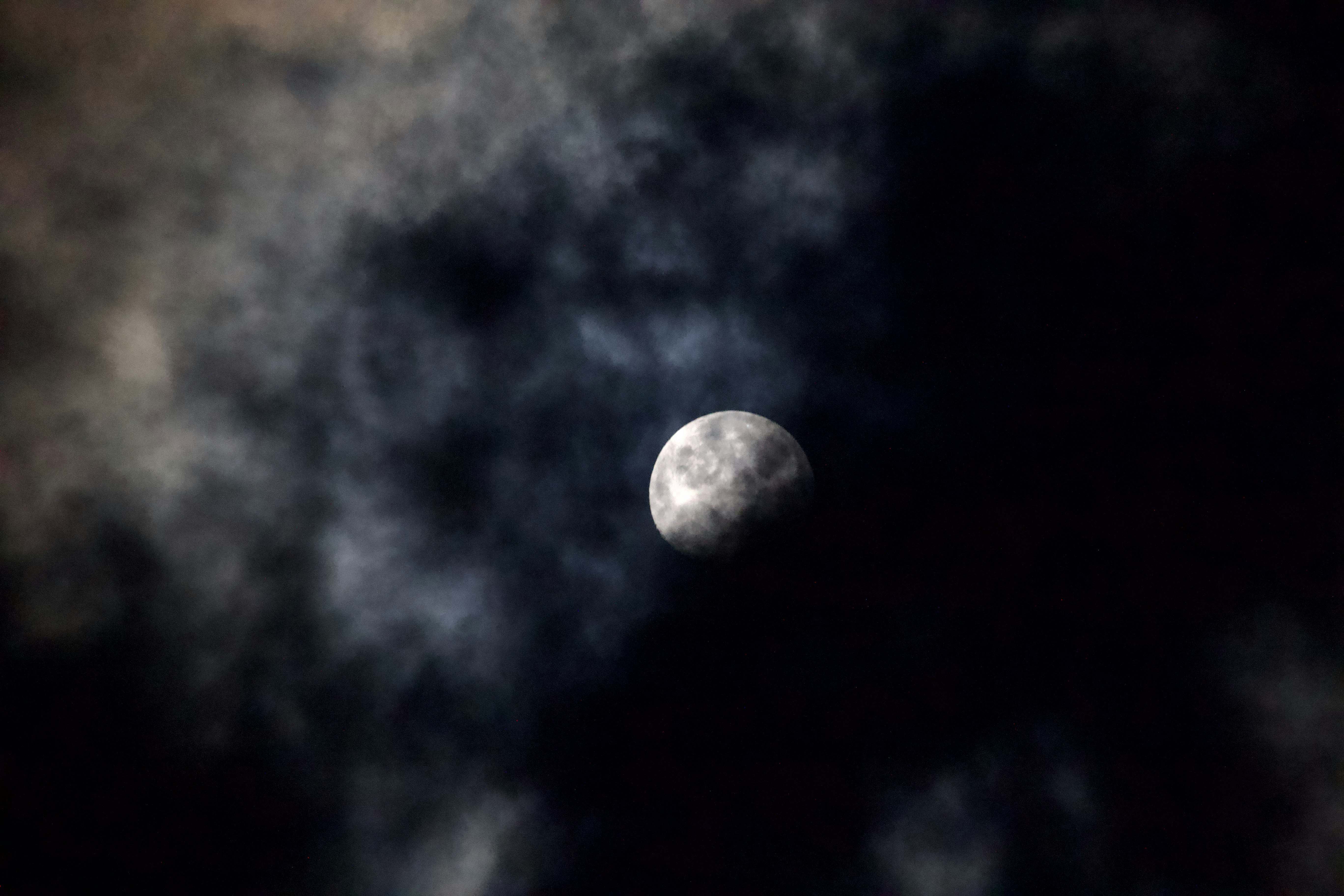 Moon over a cloudy night sky