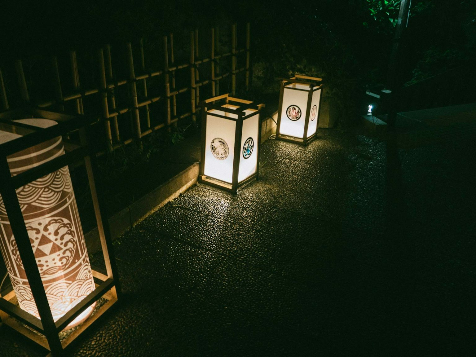 Traditional Japanese lanterns arranged along a path at night