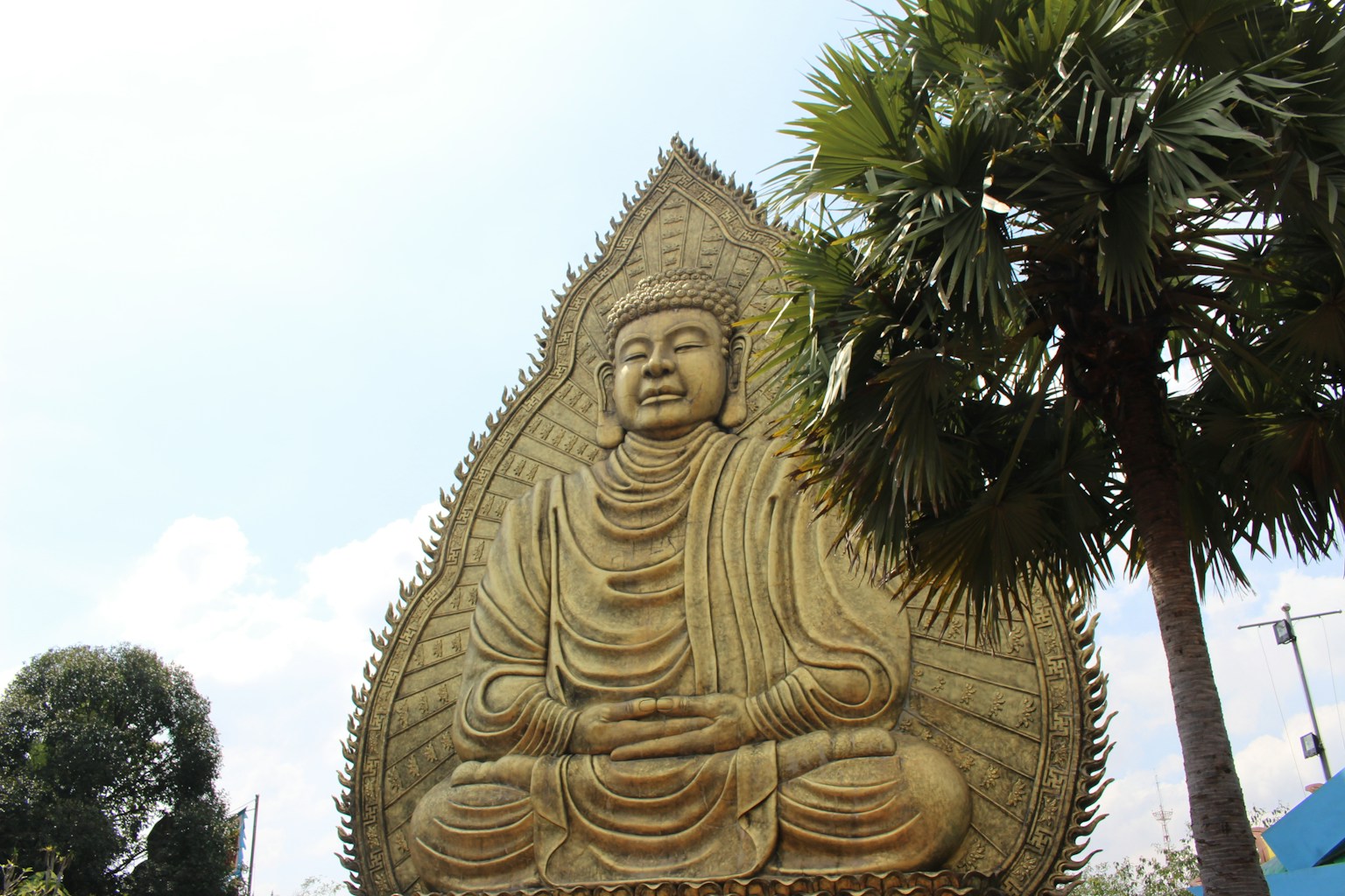 Large Buddha statue under a blue sky