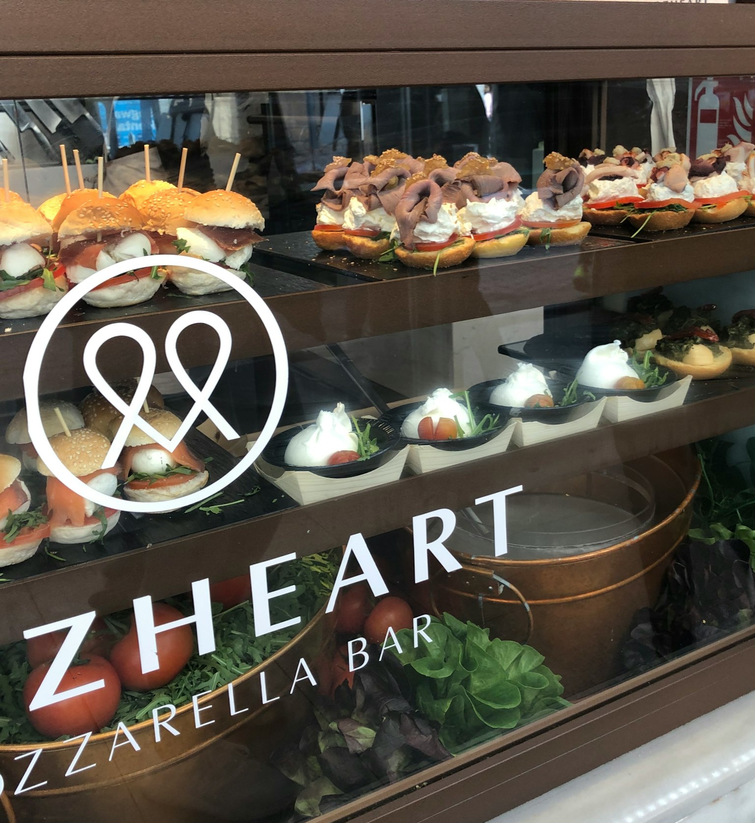Showcase of diverse dishes at a mozzarella bar featuring various ingredients