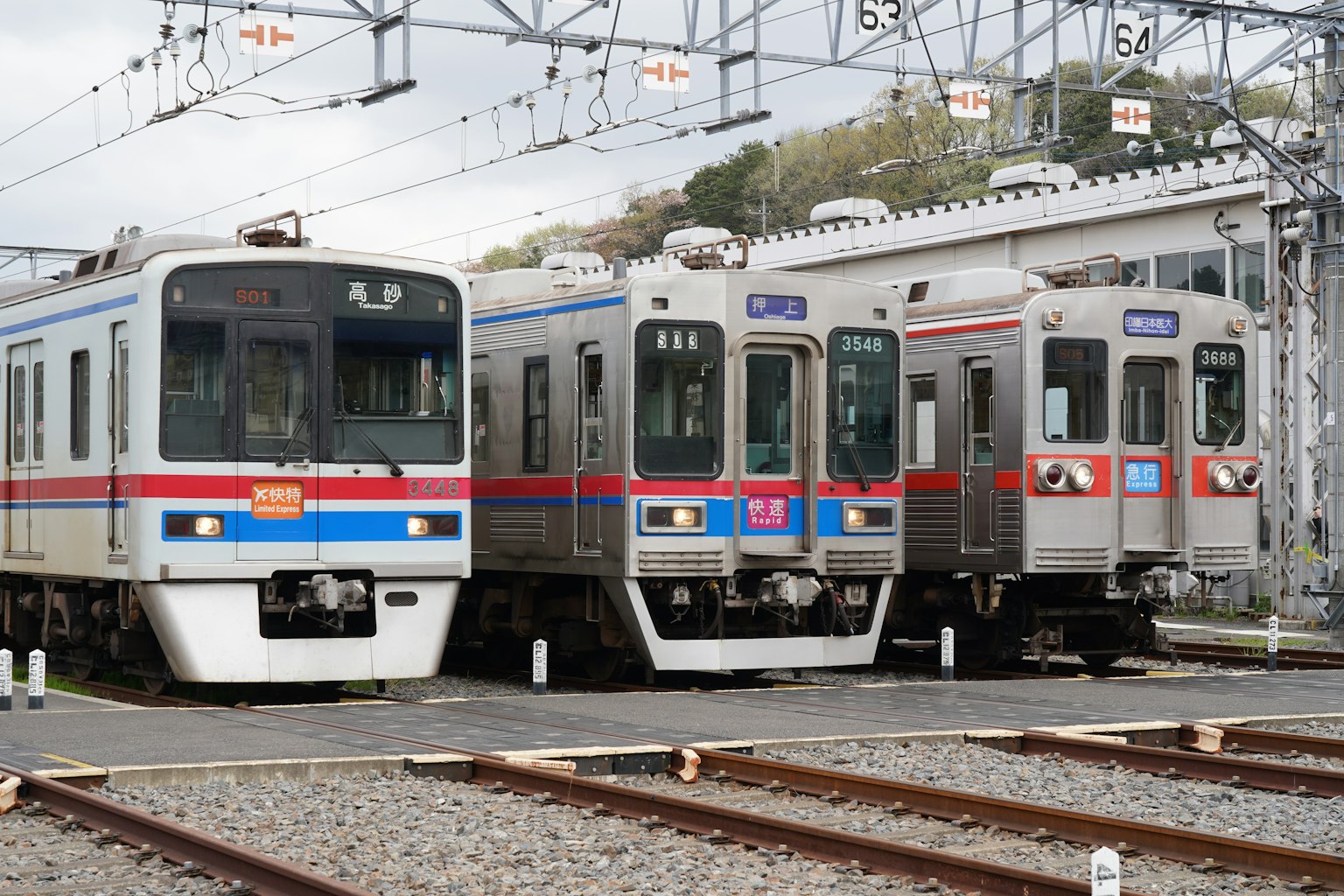 Three trains lined up on a railway track