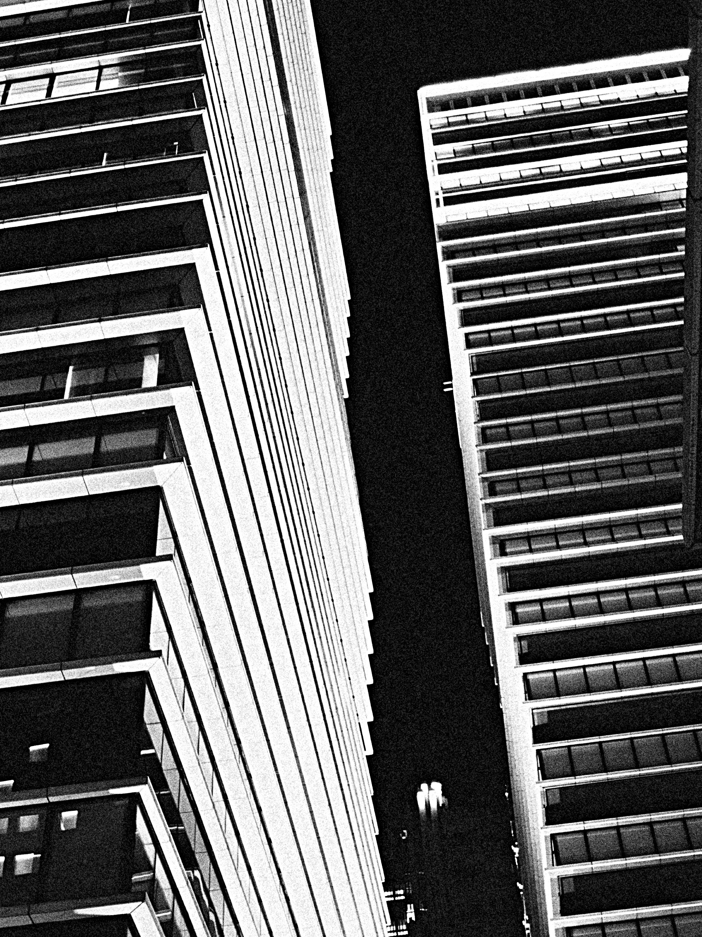 upward view of a narrow gap between tall buildings