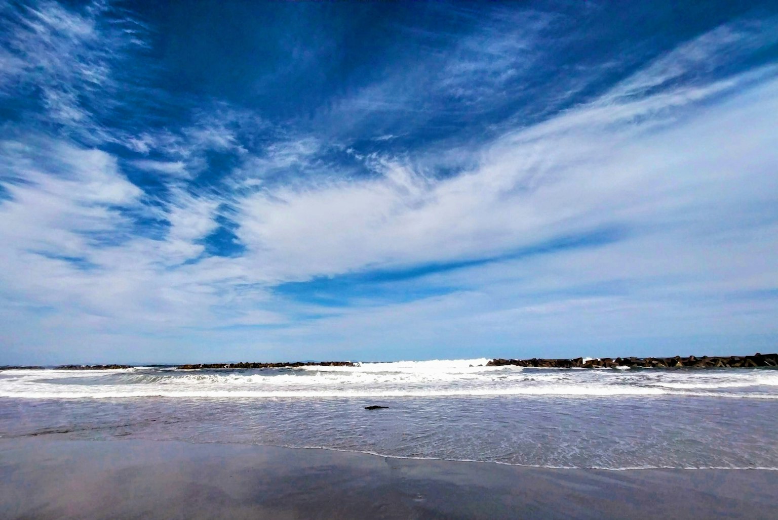 海岸风景，蓝天和滚滚波浪