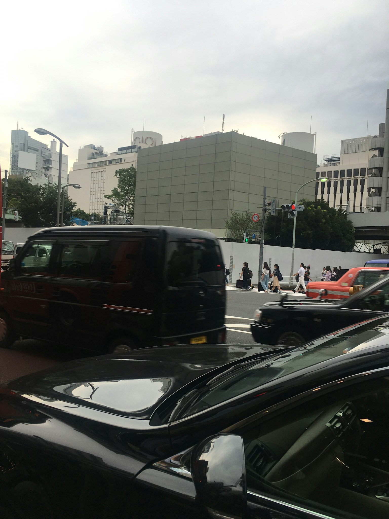 Urban scene featuring black cars and buildings in the background