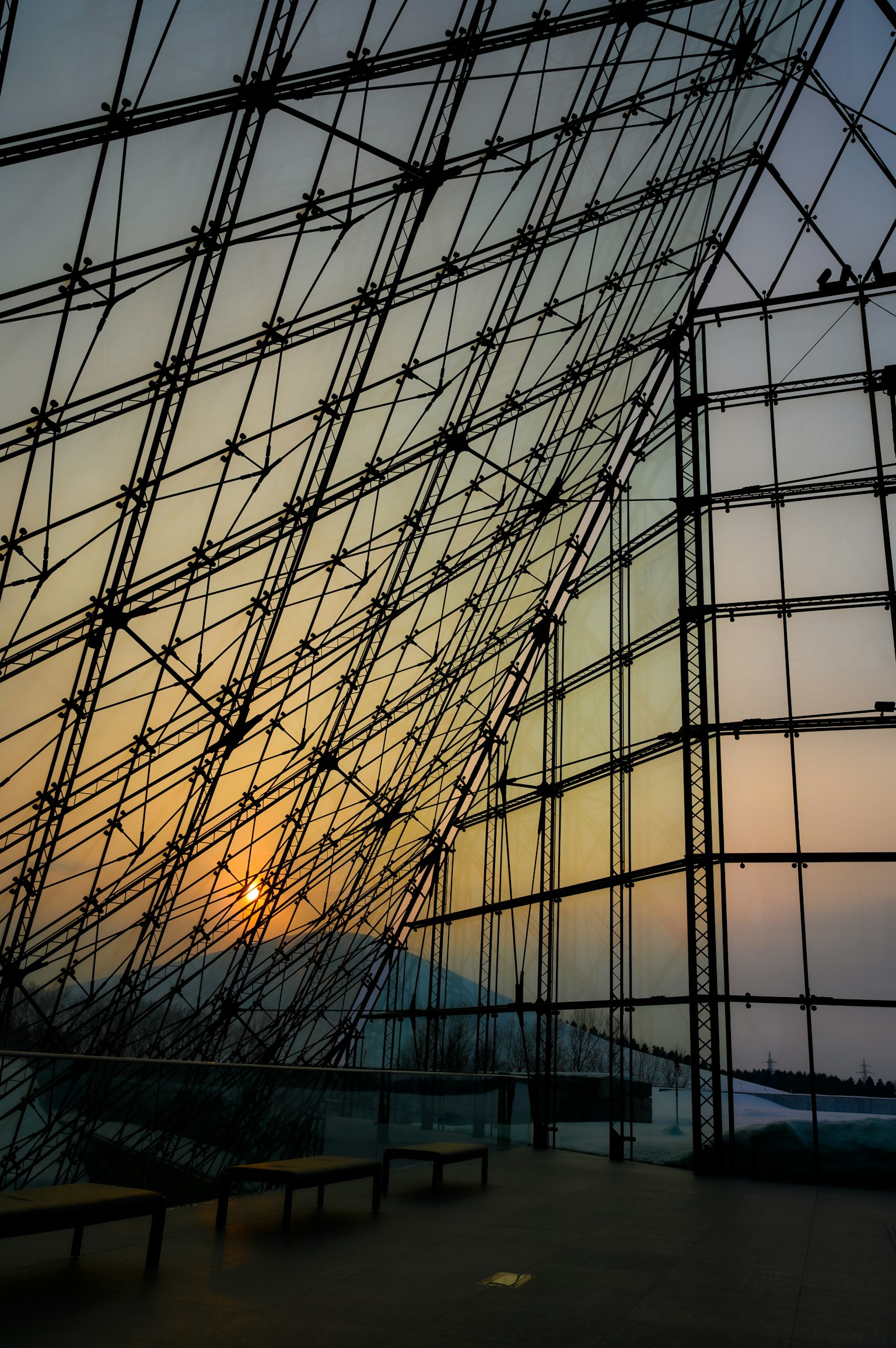 Interior structure of a glass building with sunset light