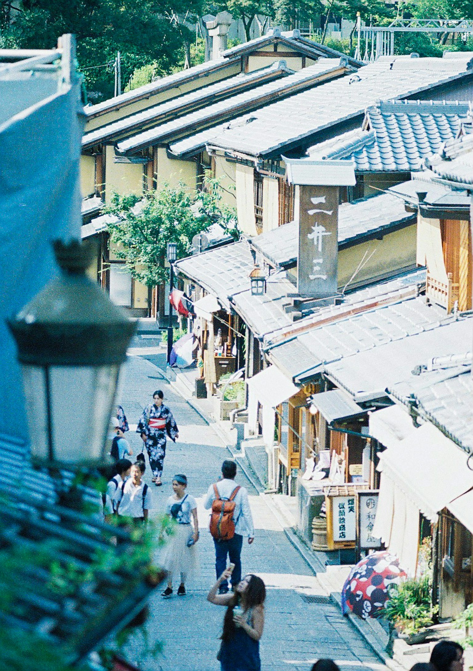 Vue pittoresque de maisons japonaises traditionnelles avec des gens marchant dans une rue en pavés