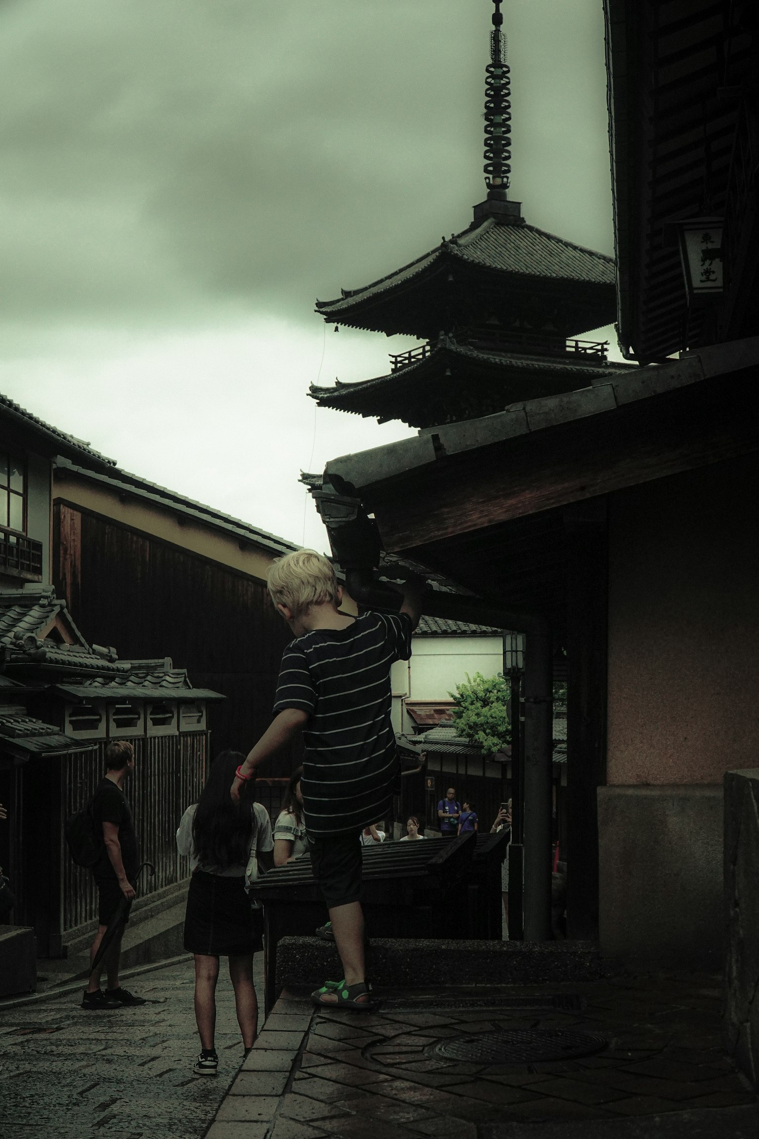 Children walking in an old town with traditional buildings and a cloudy sky