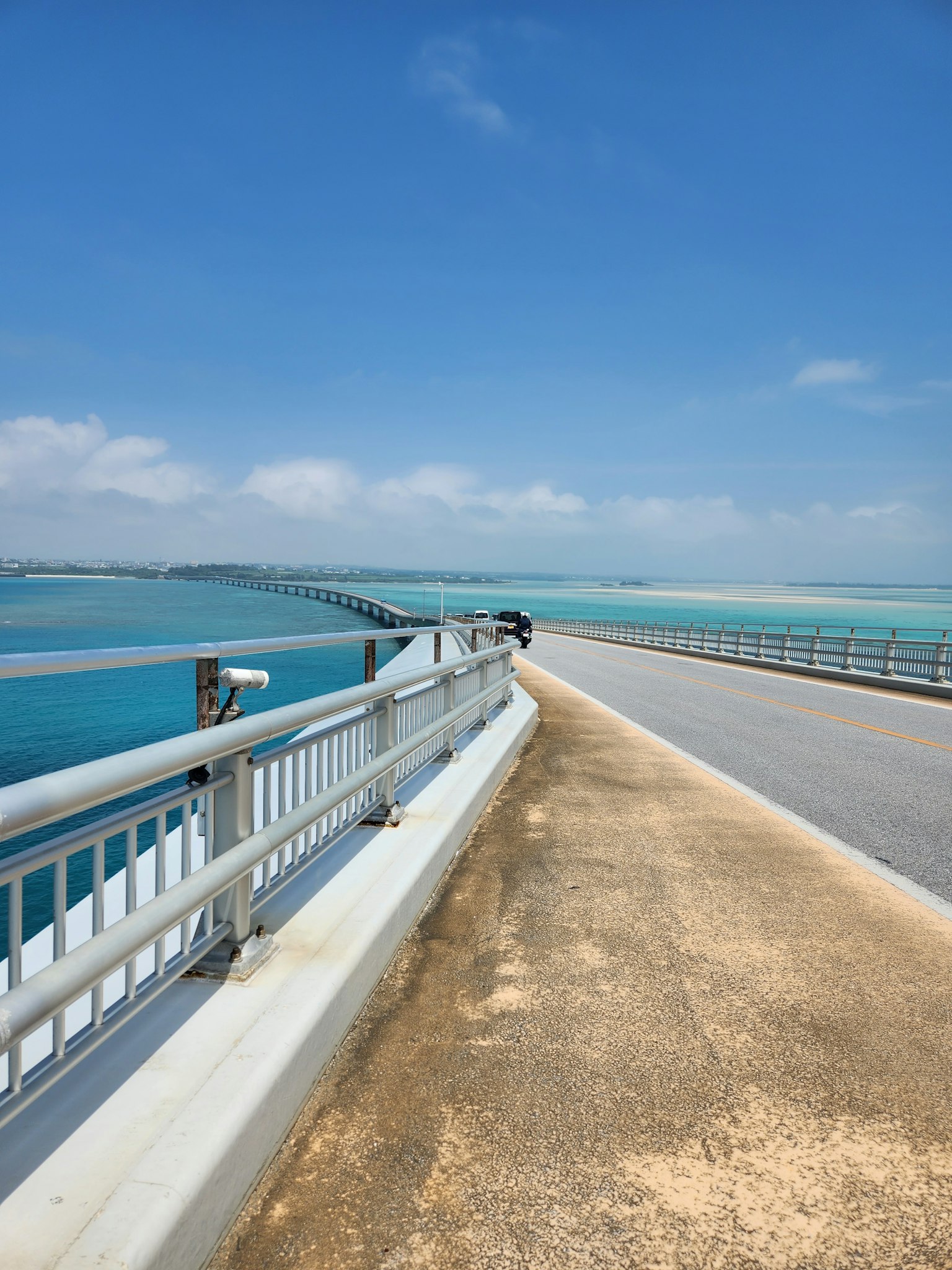 View of a bridge over turquoise water under a clear blue sky