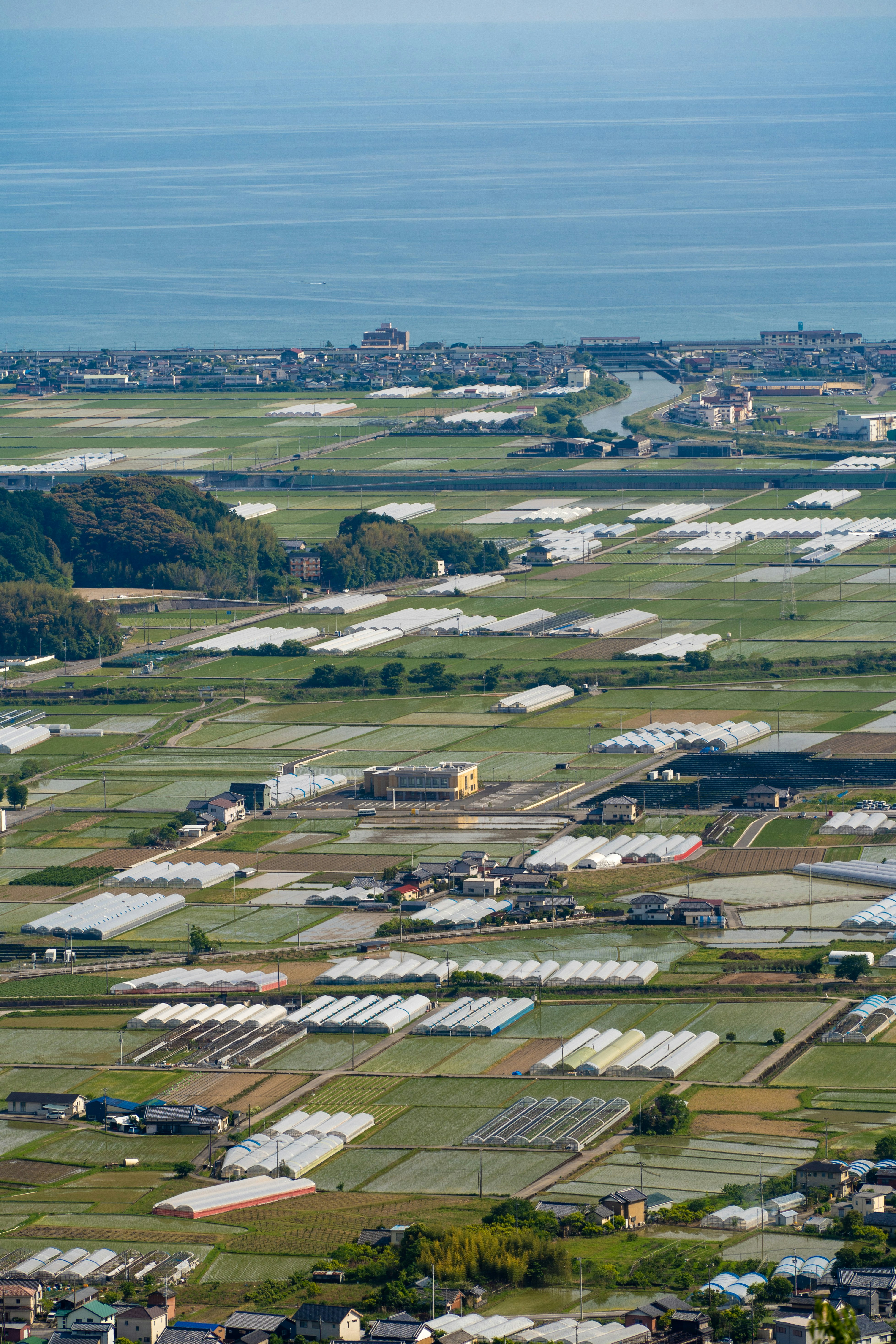 Aerial view of solar panels across farmland in a rural landscape