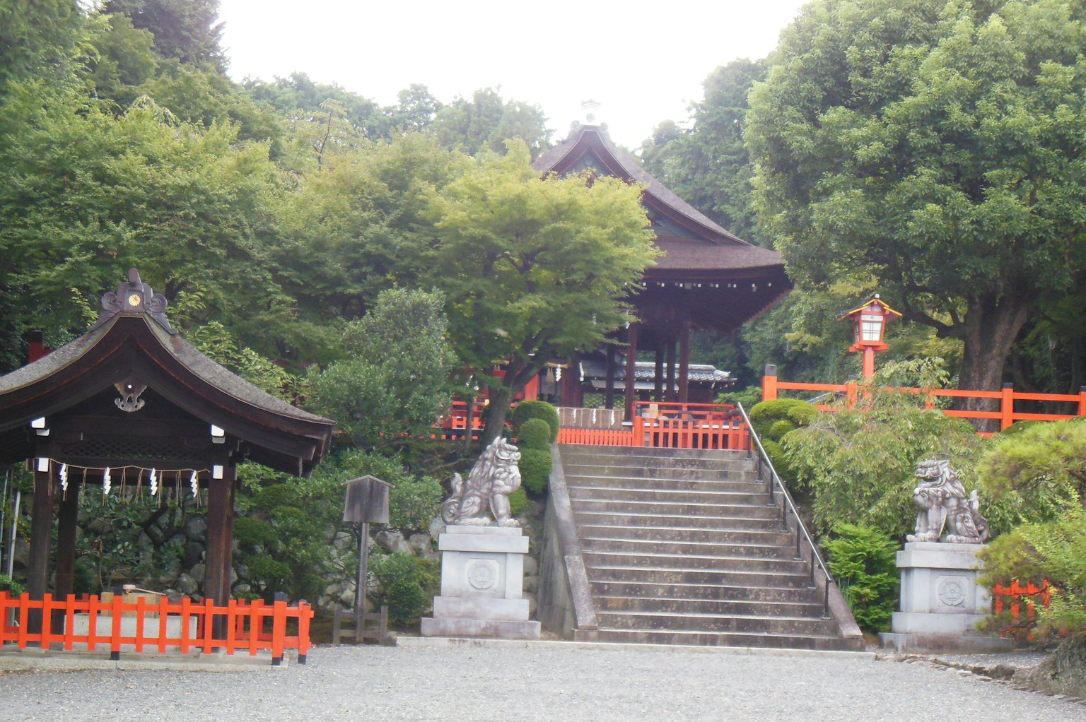 Traditional Japanese shrine surrounded by greenery and stone steps