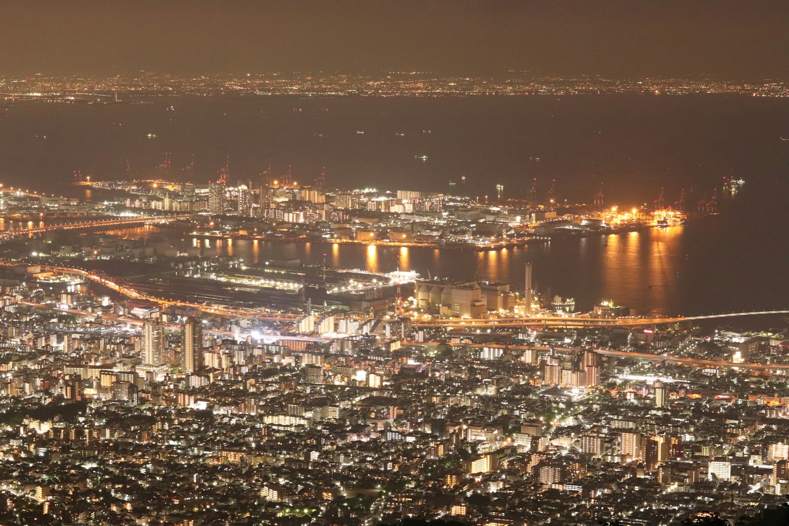 夜晚沿海岸线照亮的城市景观的鸟瞰图