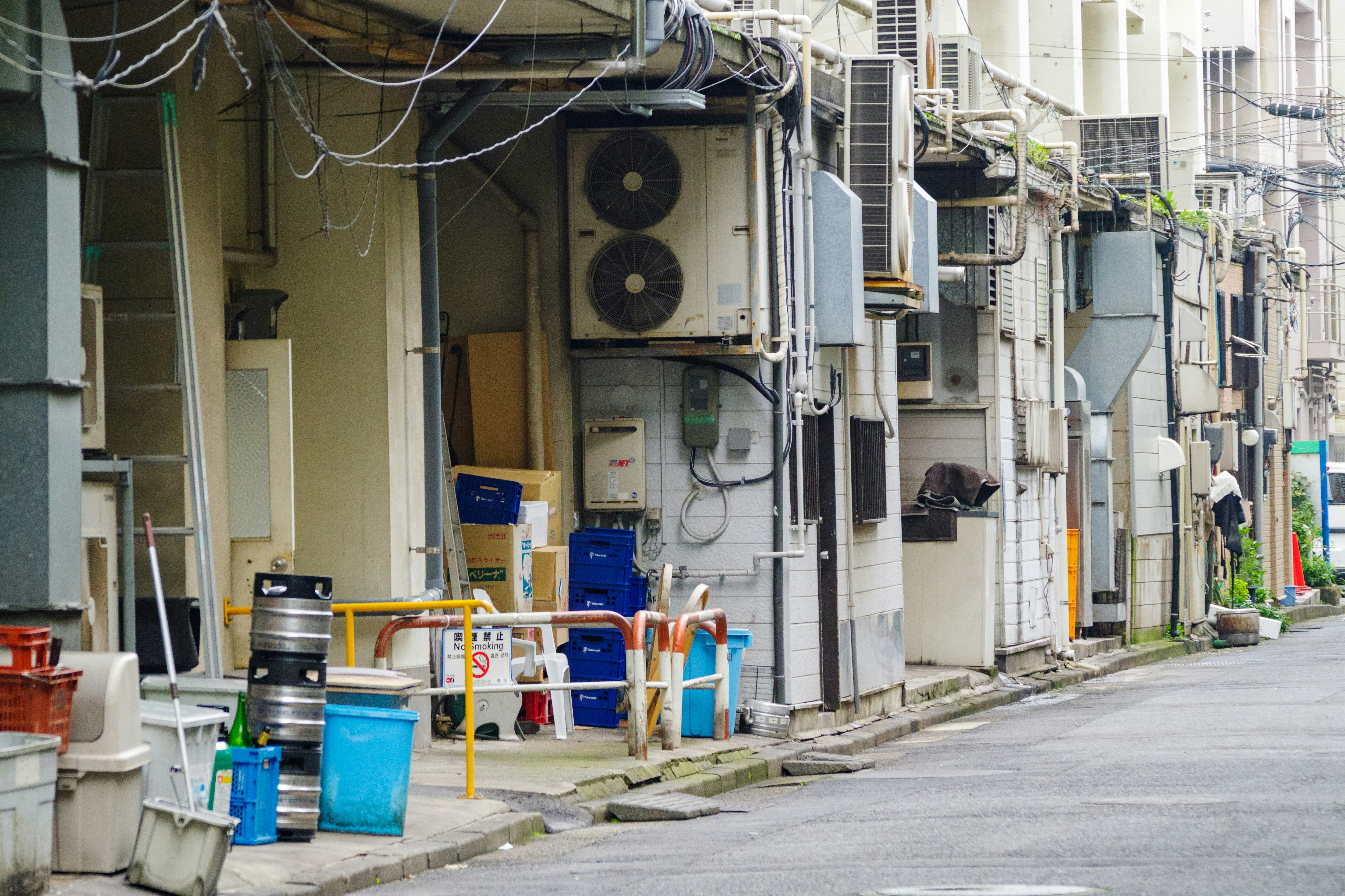 巷道墙边排列的管道、工业设备与纸箱
