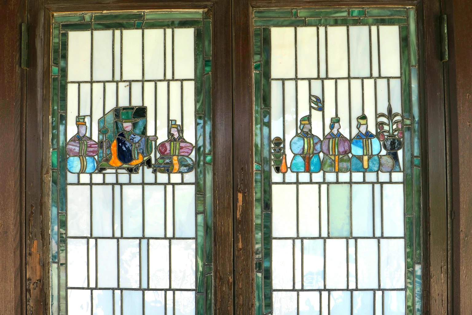Colorful figures depicted in stained glass windows