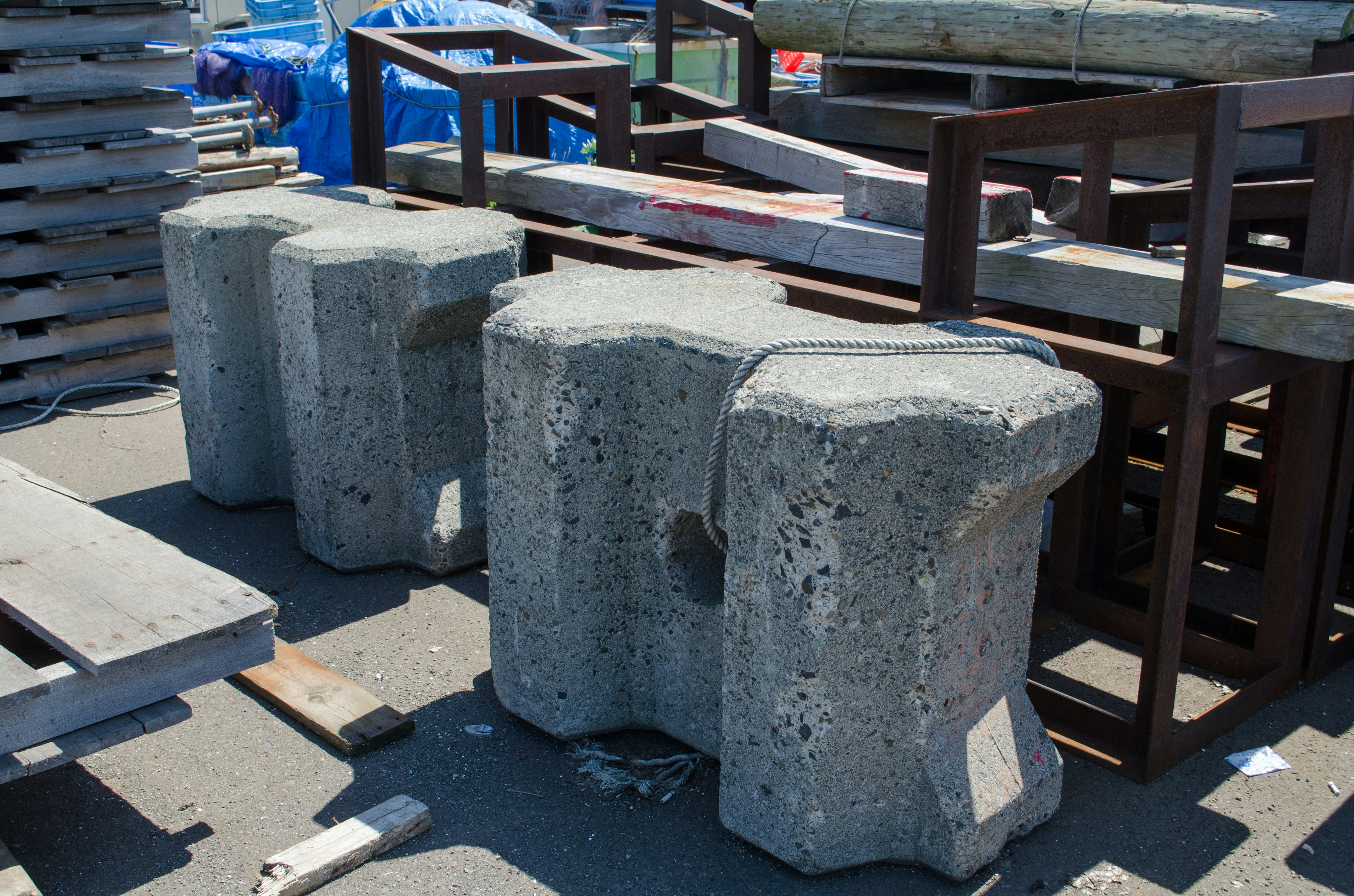 Outdoor display of concrete benches and wooden chairs