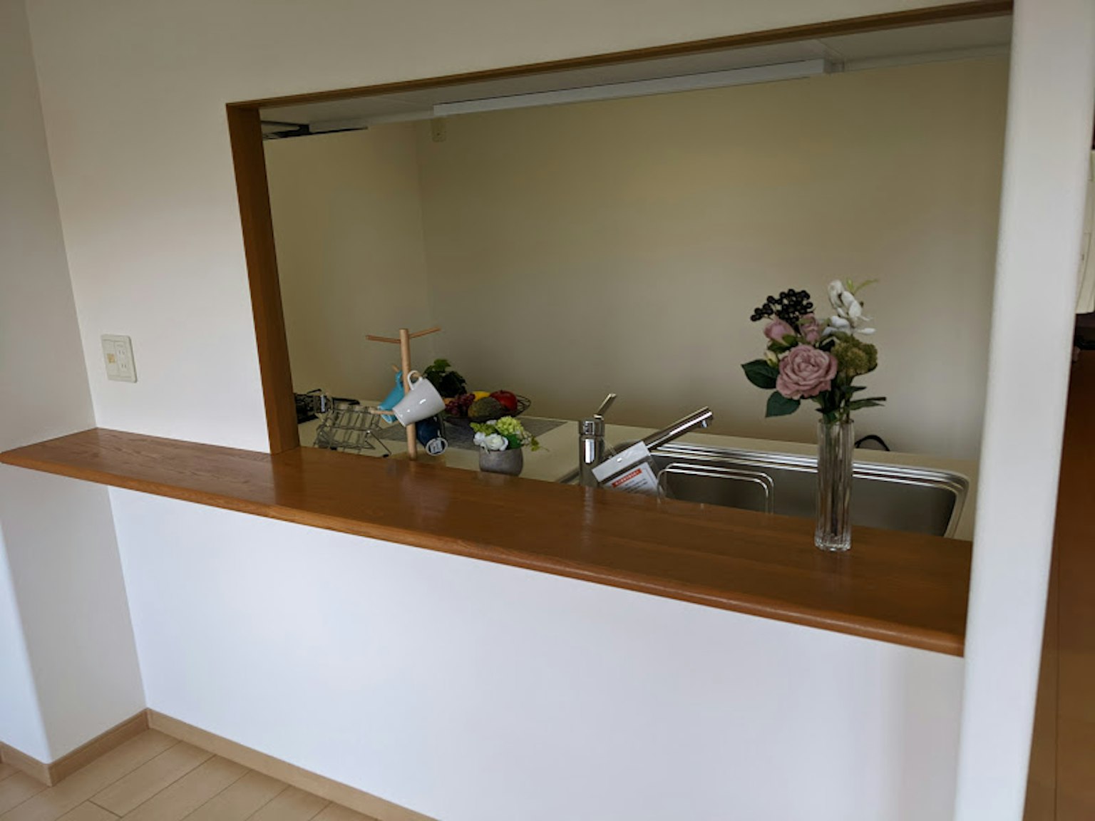 Room featuring a natural wooden counter and a simple kitchen