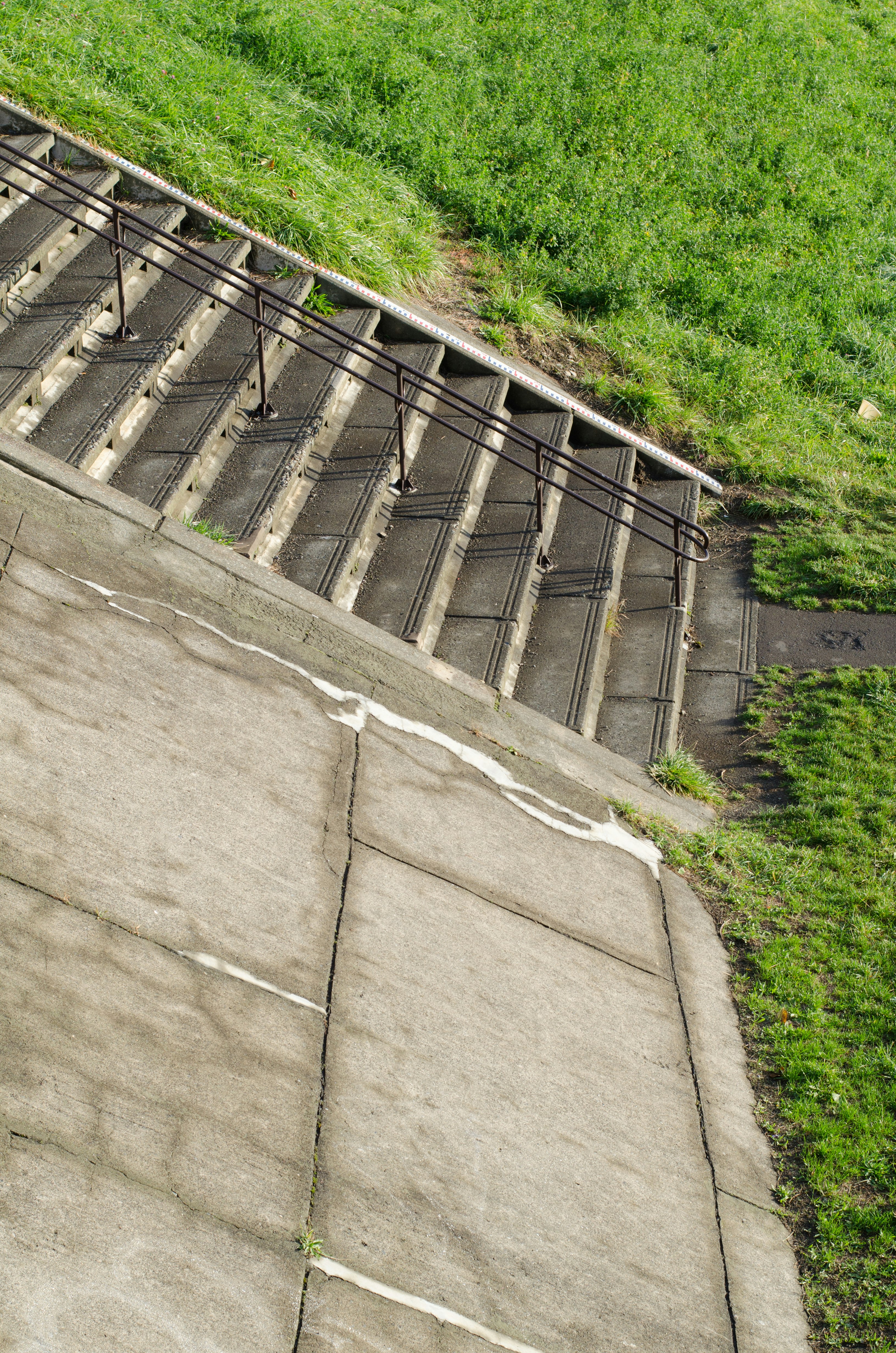 Diagonal concrete stairs with grassy area nearby