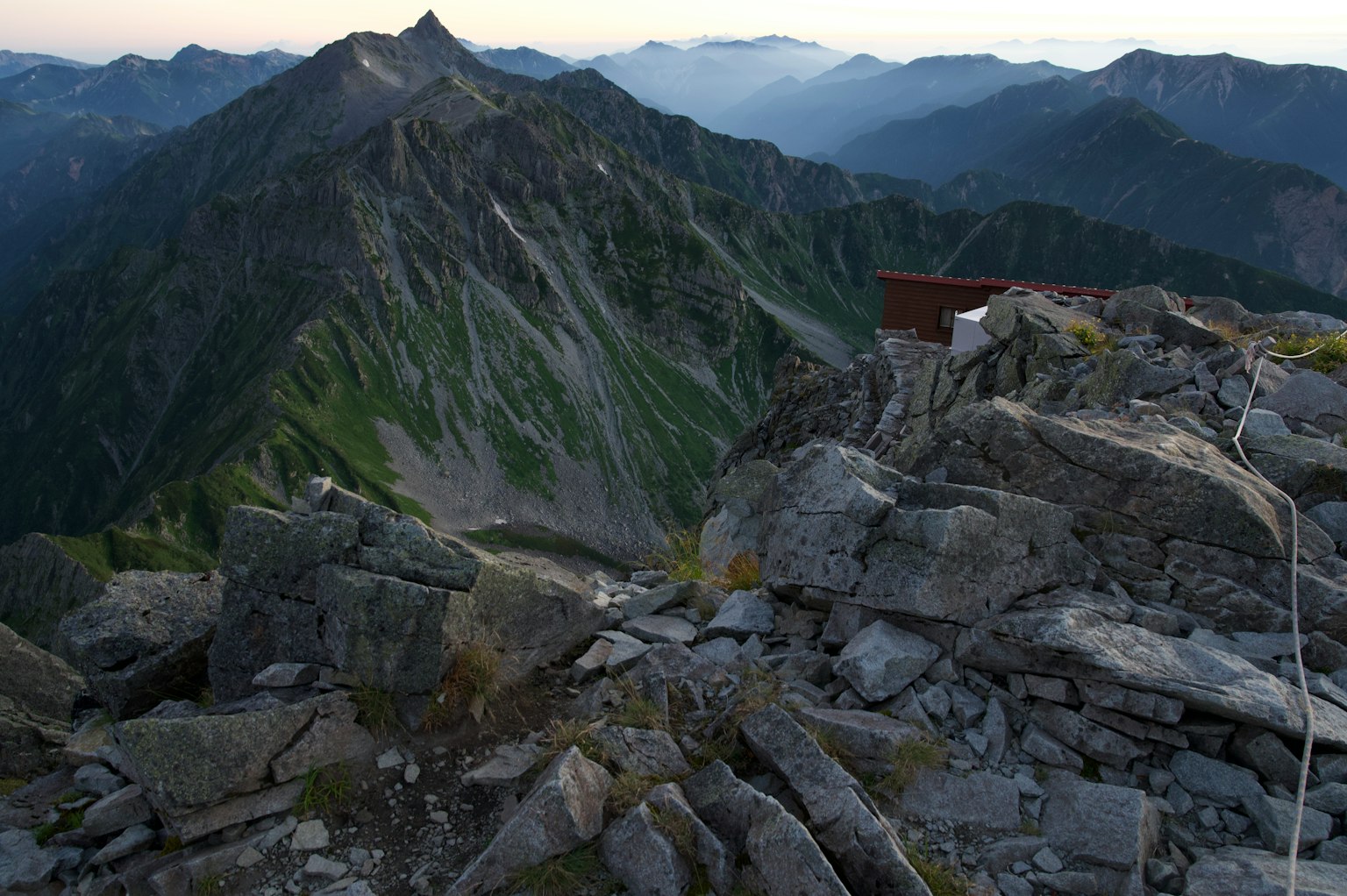 View from the mountain peak with rocky terrain and distant mountains