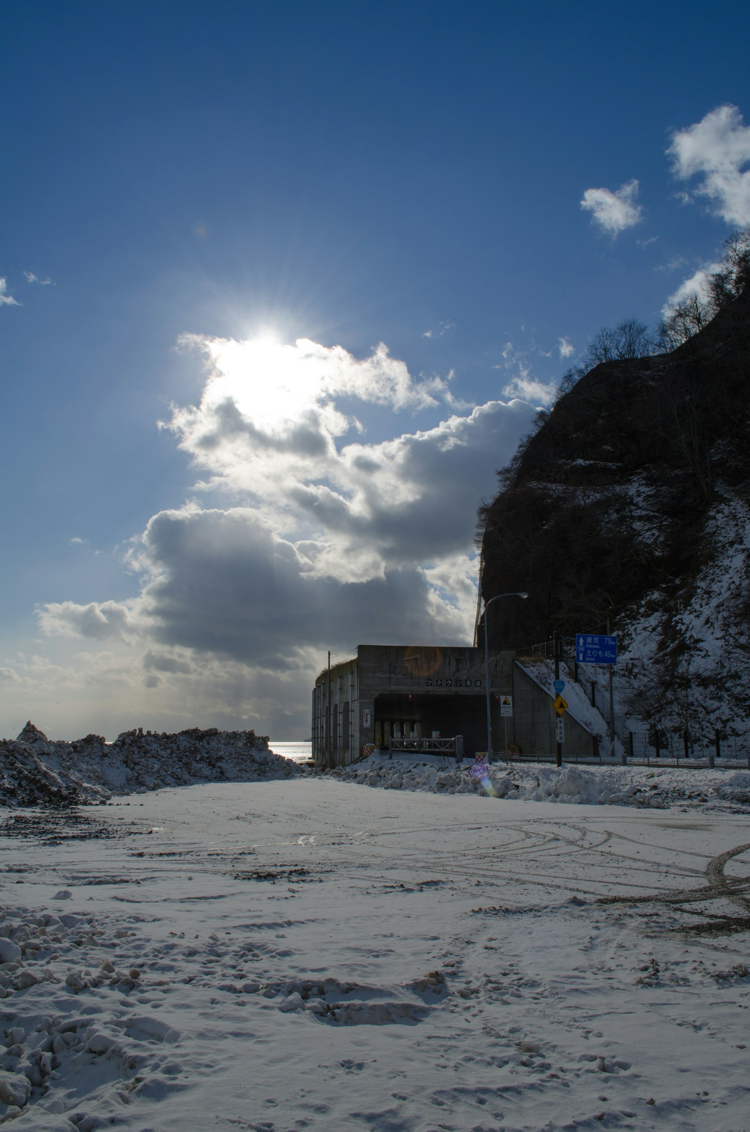 Building on snowy landscape under a blue sky