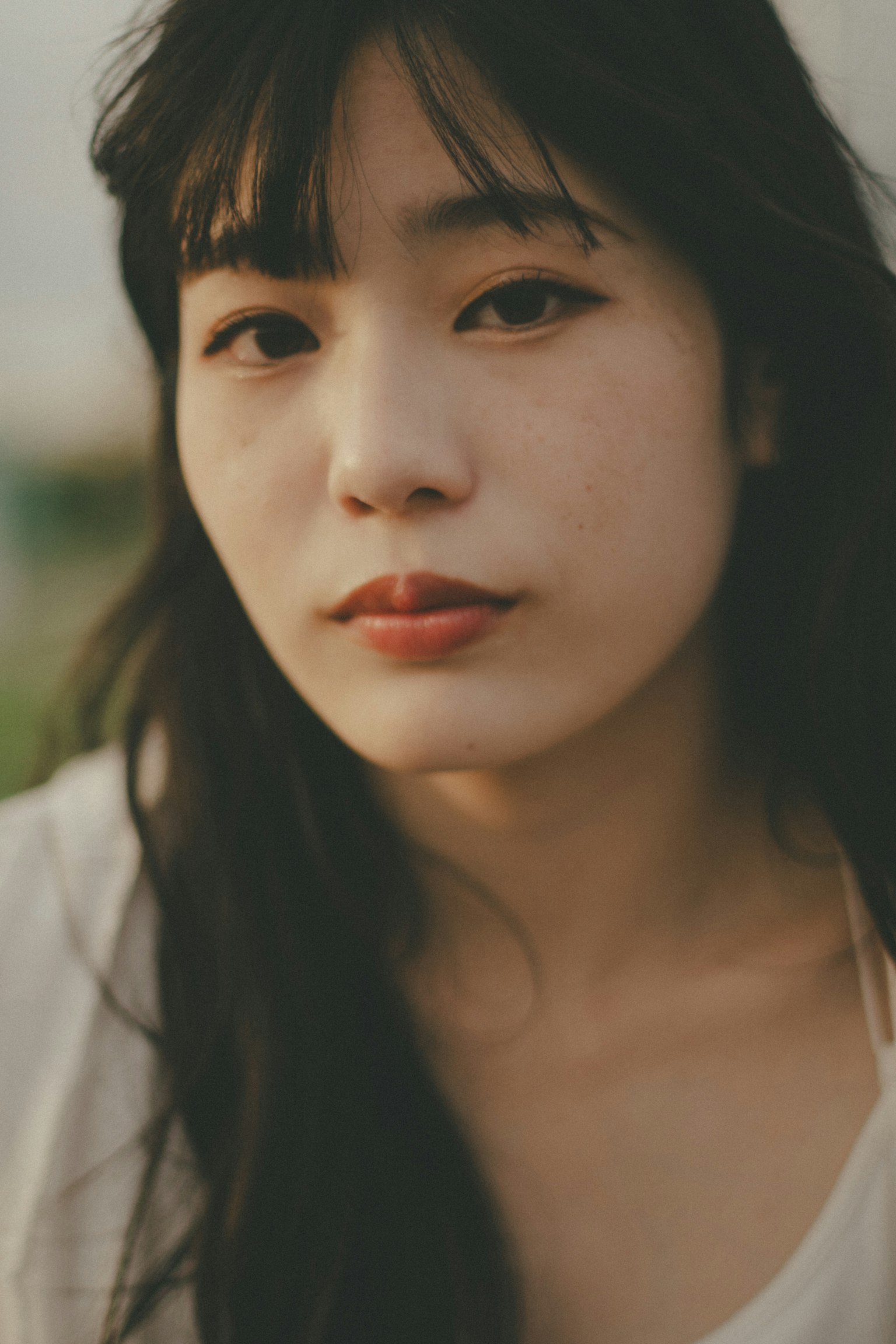 Portrait of a young woman smiling in natural light