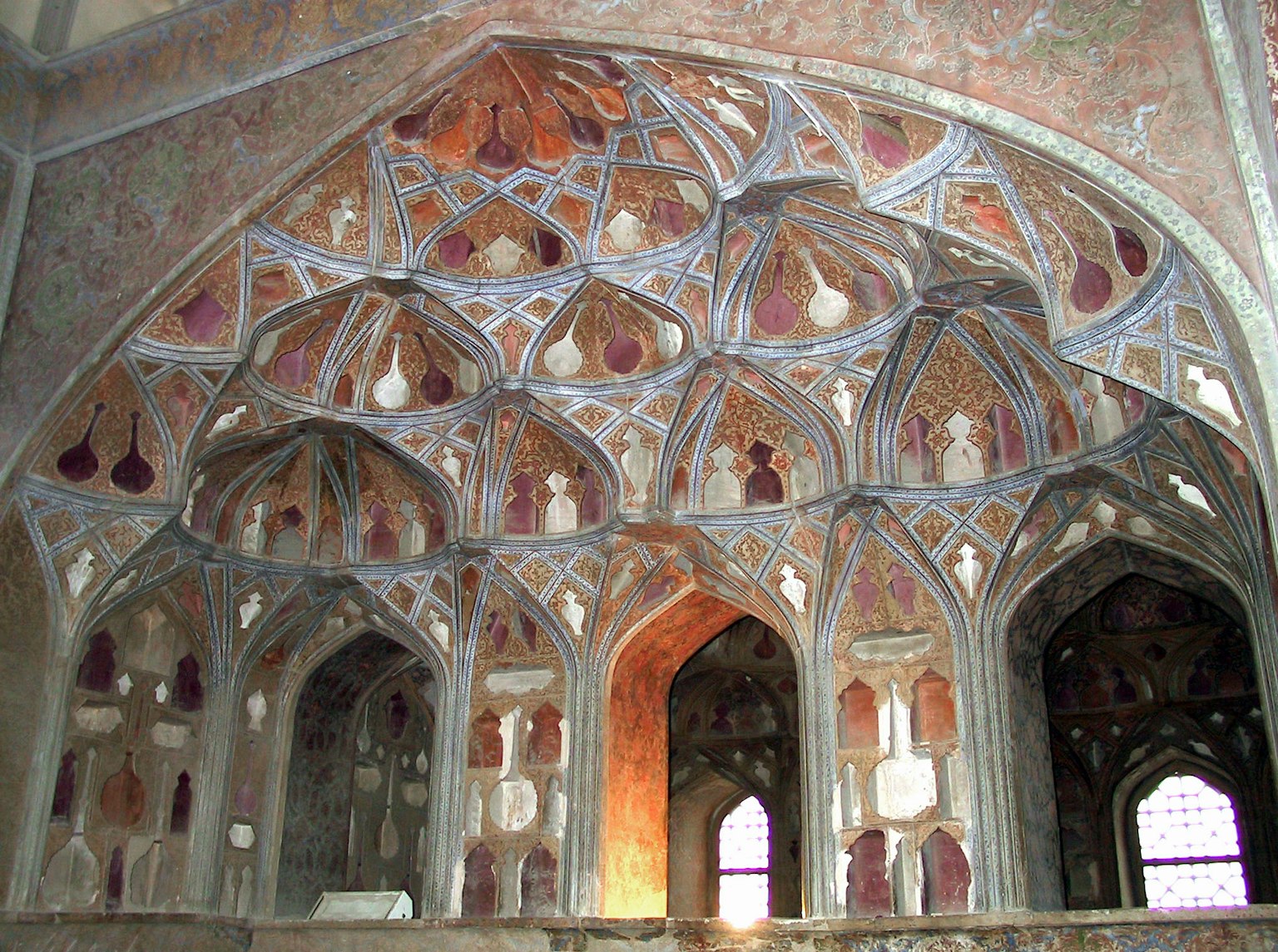 Interno di un antico edificio con motivi decorativi intricati e colori sulle pareti