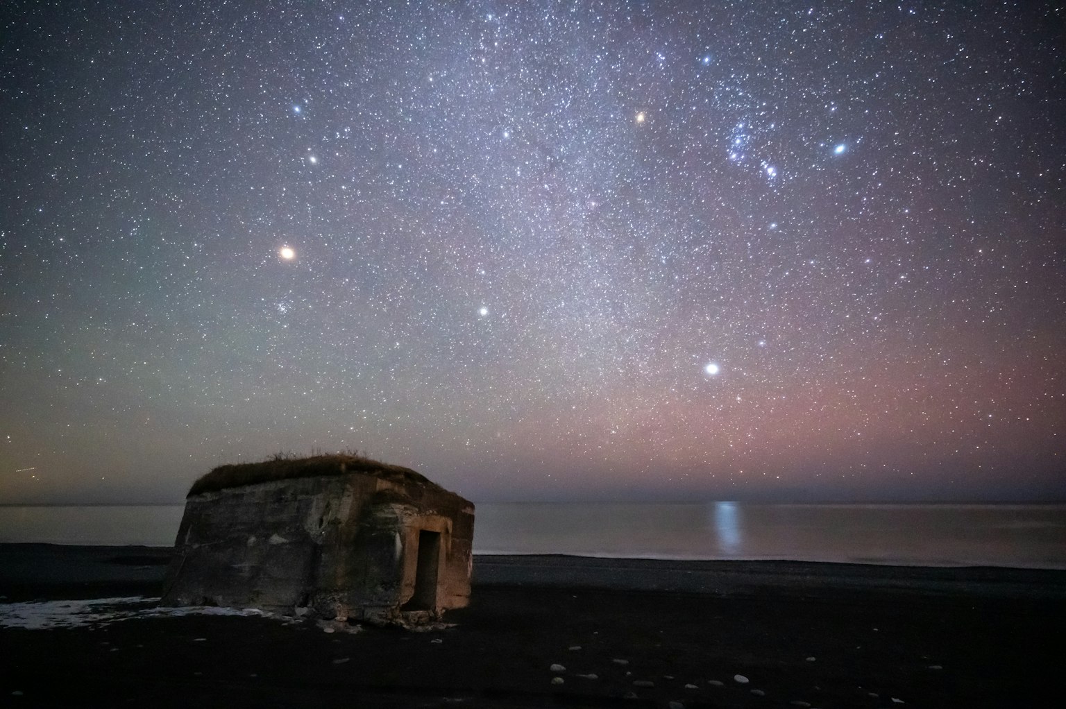 Alte Hütte unter einem sternenklaren Himmel am Meer