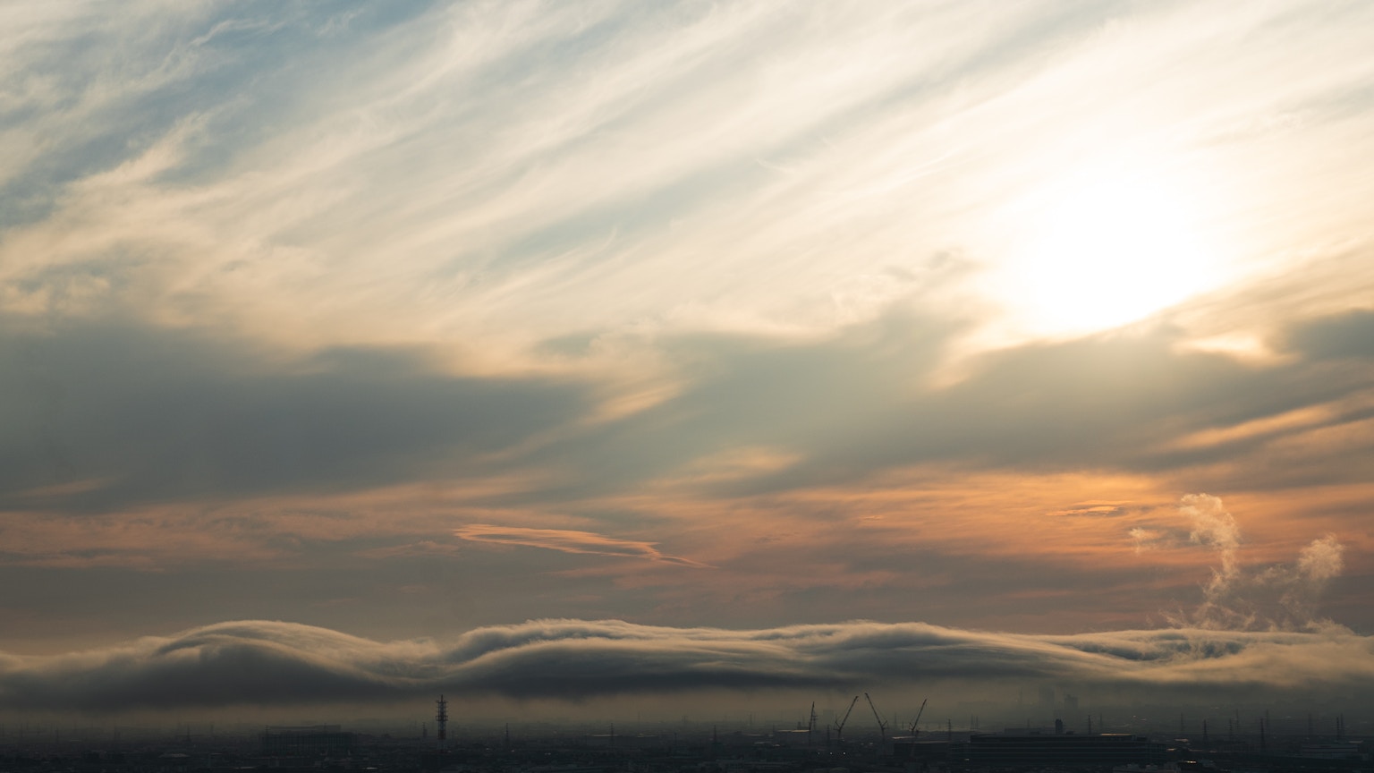 Beautiful landscape of clouds and sunset soft colors in the sky silhouette of distant mountains