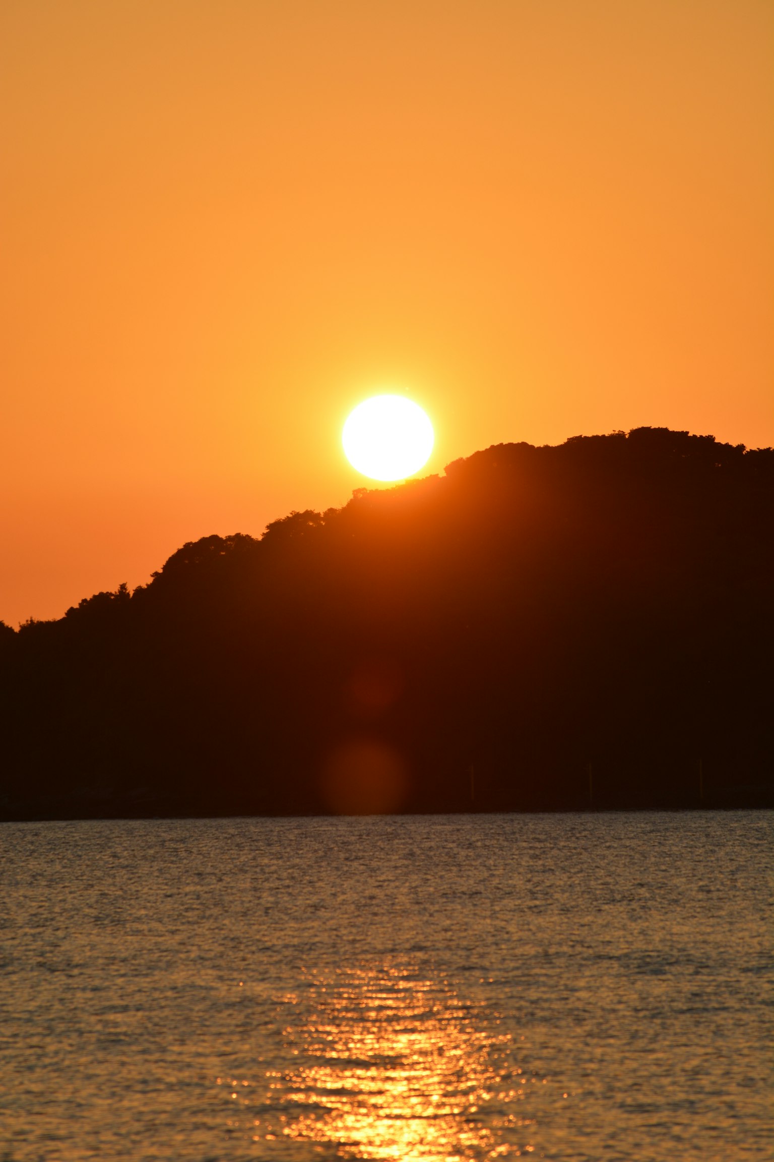 Bellissimo tramonto su una collina con acqua scintillante