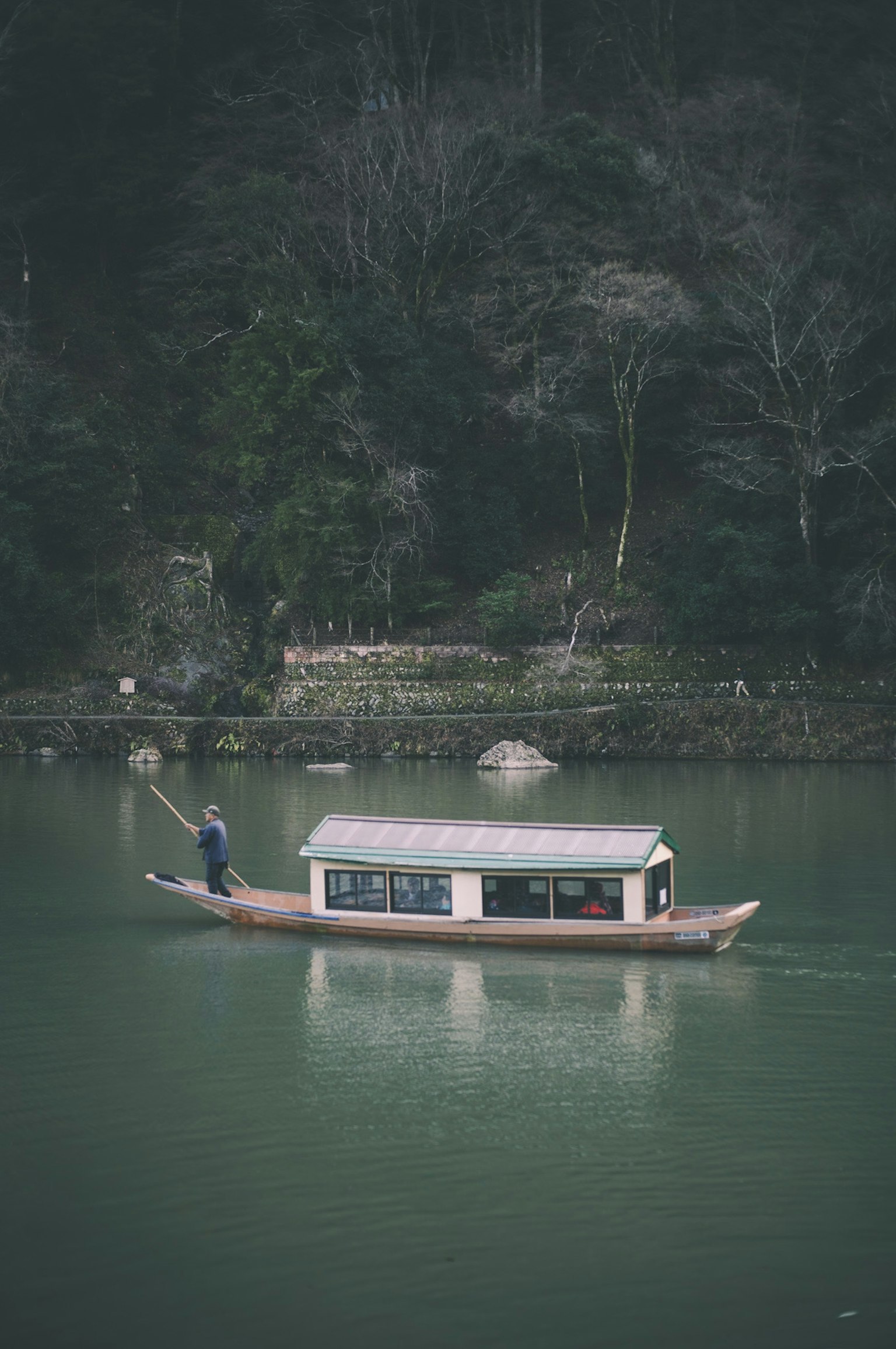Bateau en bois traditionnel avec un pêcheur sur un lac calme
