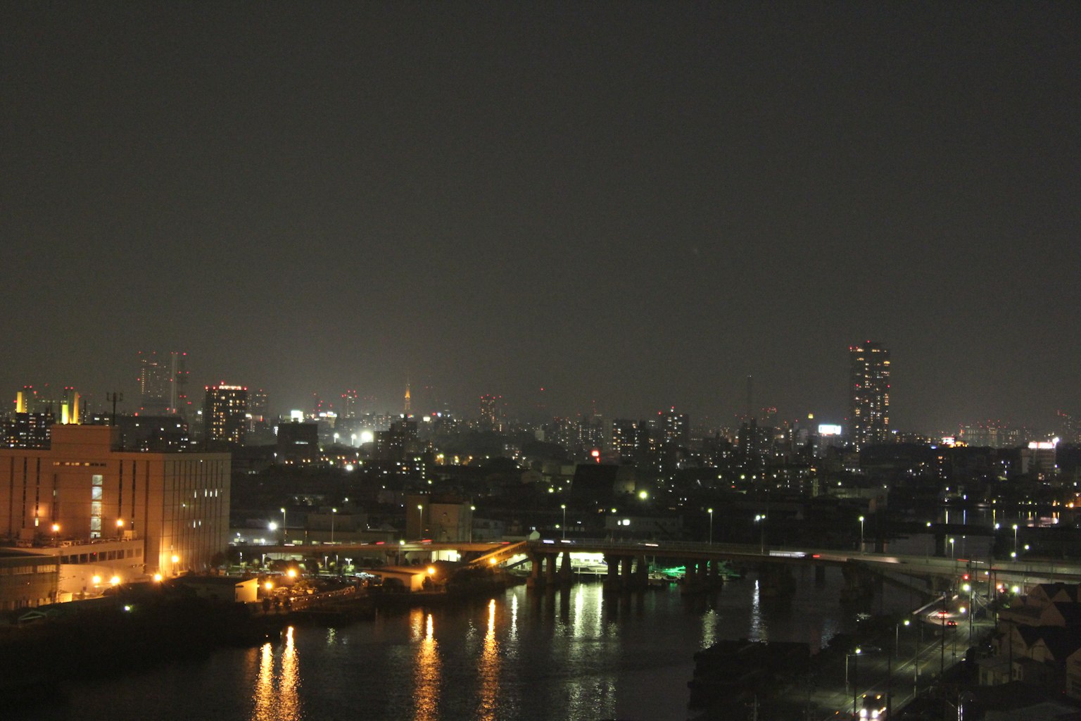 Night view of Tokyo riverbank with illuminated skyscrapers