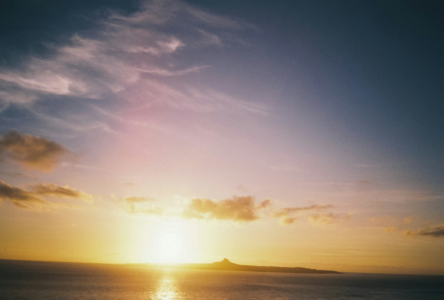Beautiful landscape of sunset over the ocean with a distant island