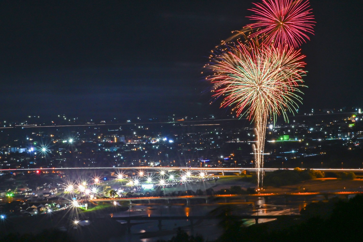 Colorful fireworks lighting up the night sky over a city