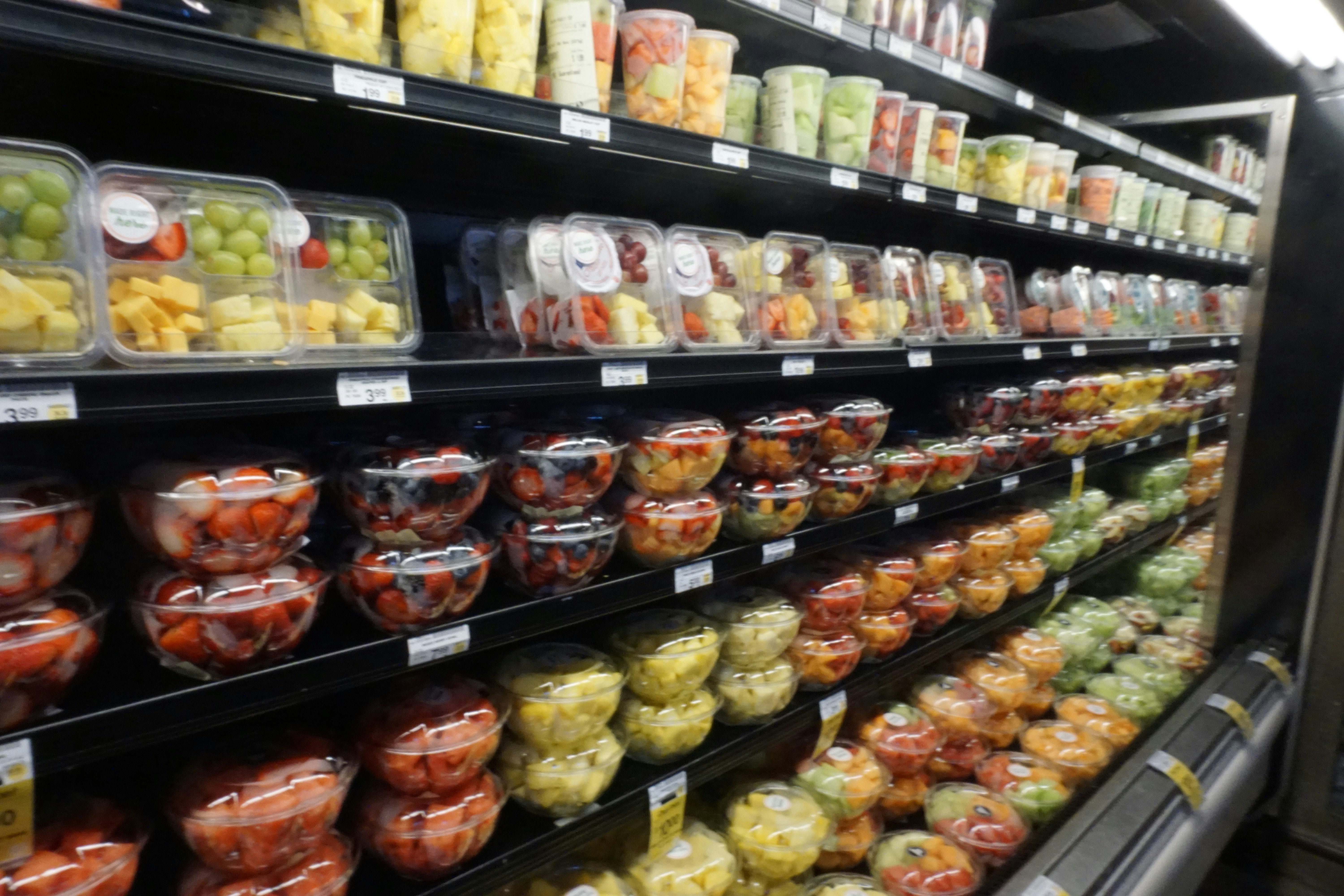 refrigerated display case with colorful prepared foods and salads