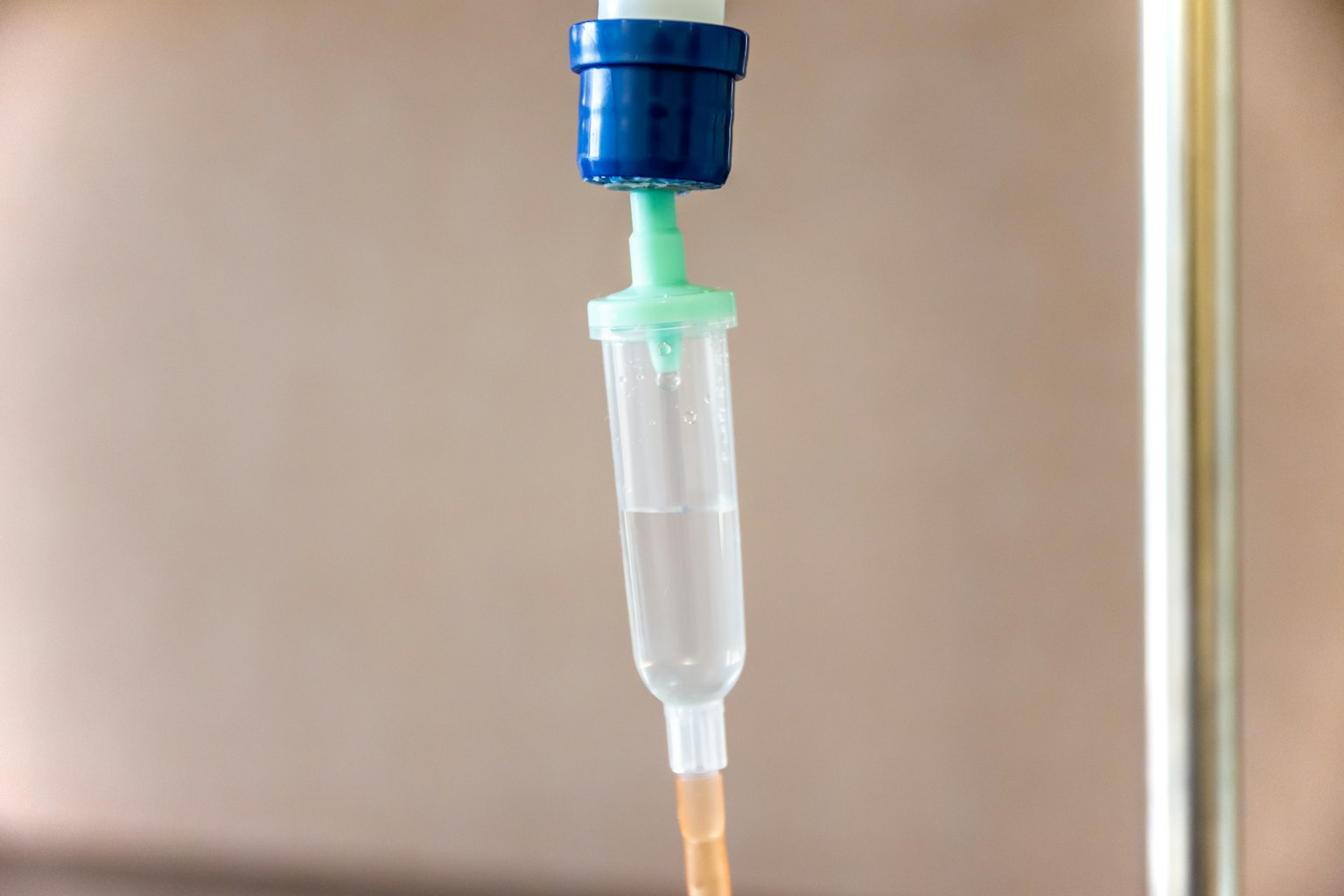IV drip setup featuring a clear tube and blue cap