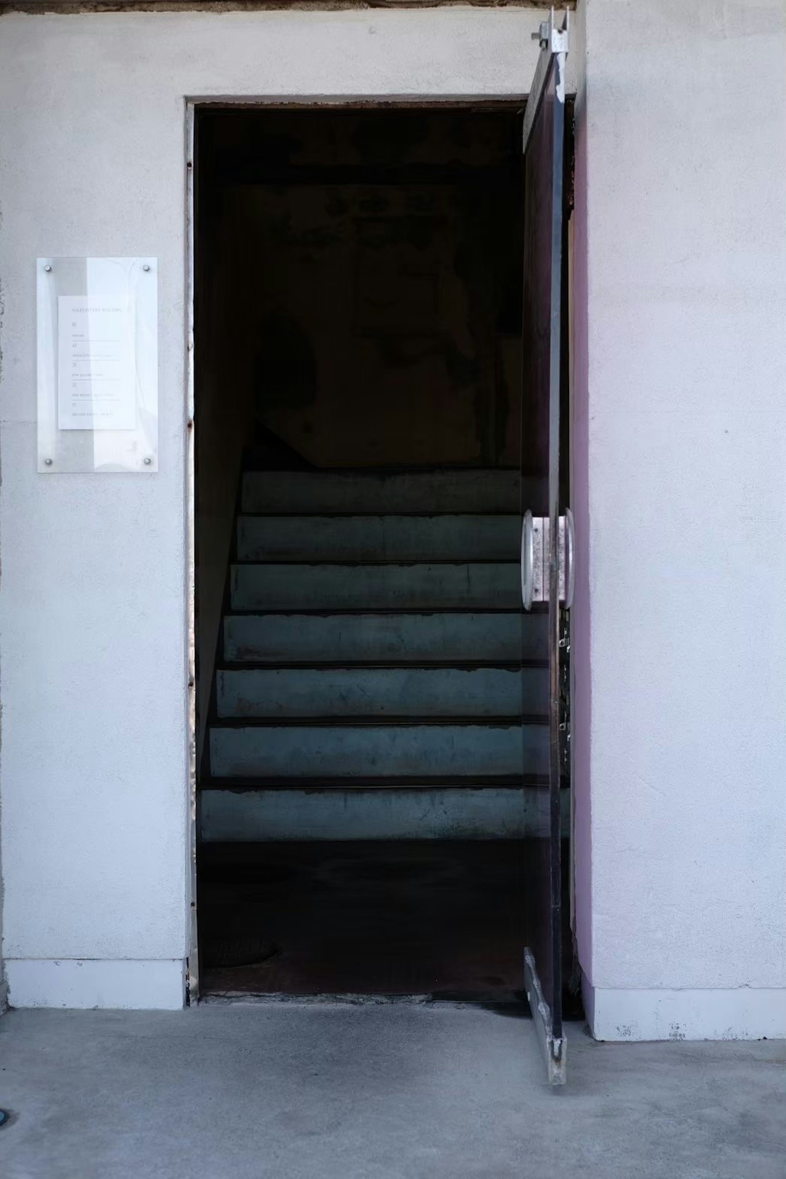 通向黑暗空间的楼梯的开放门的图像