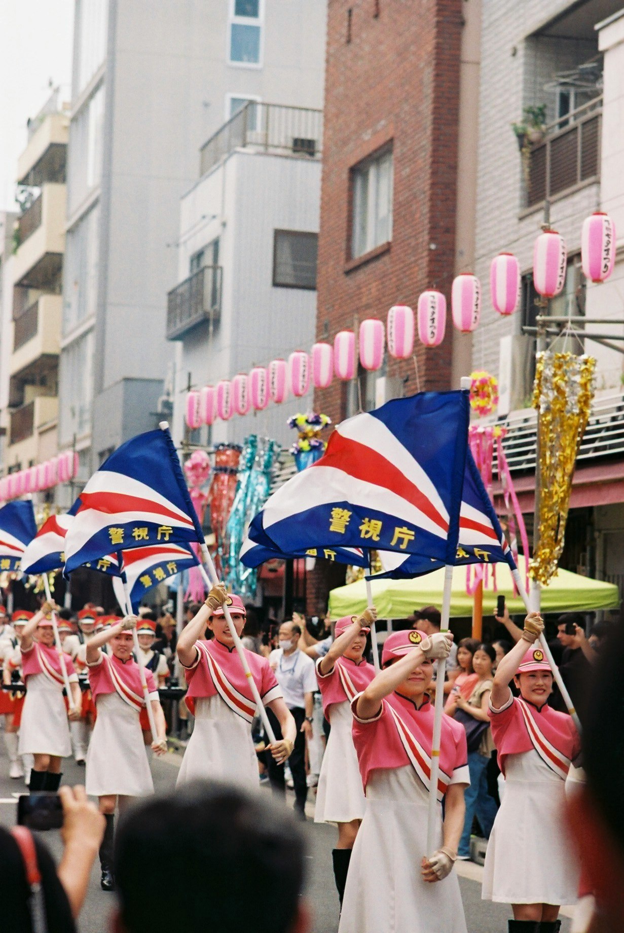 children marching in a parade holding flags