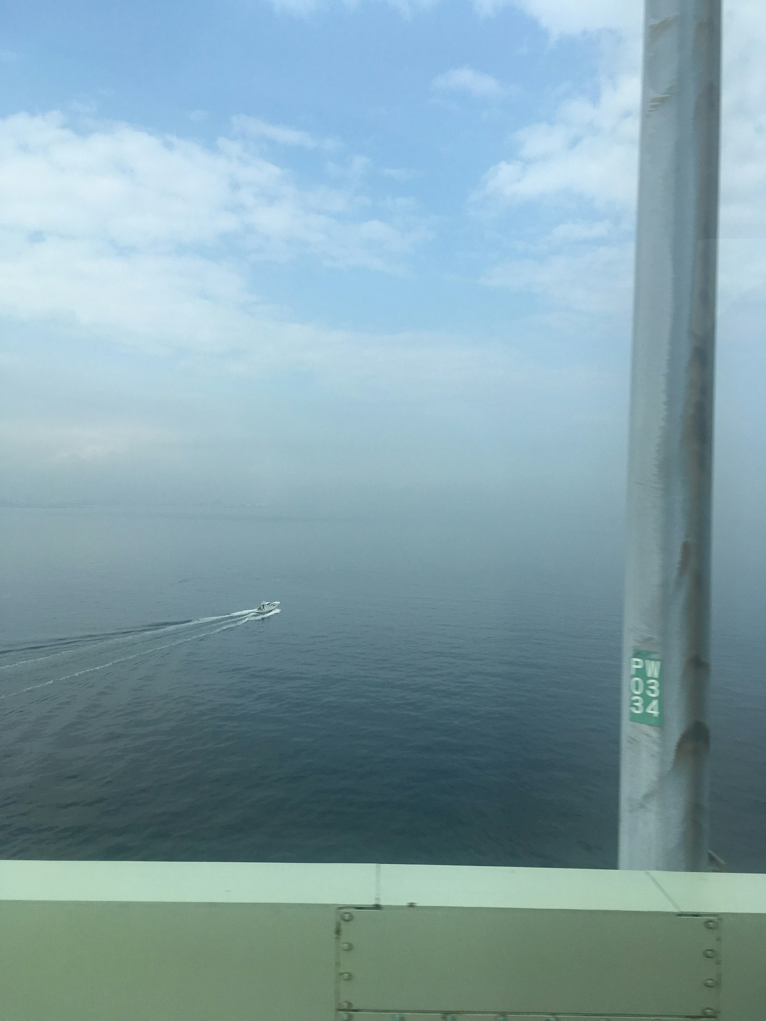 A boat navigating through fog over calm waters