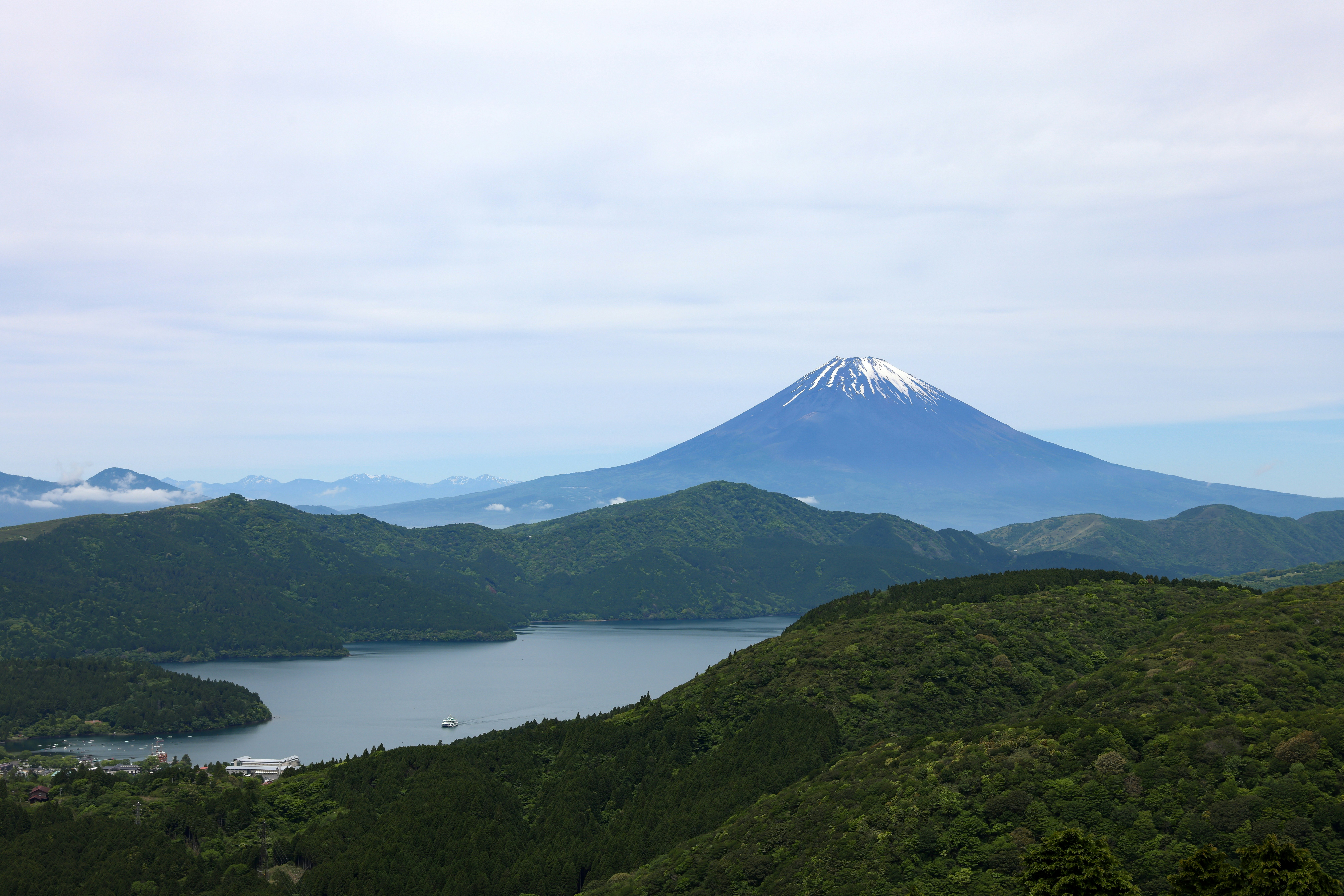green ridgeline overlooking a mountain and lake
