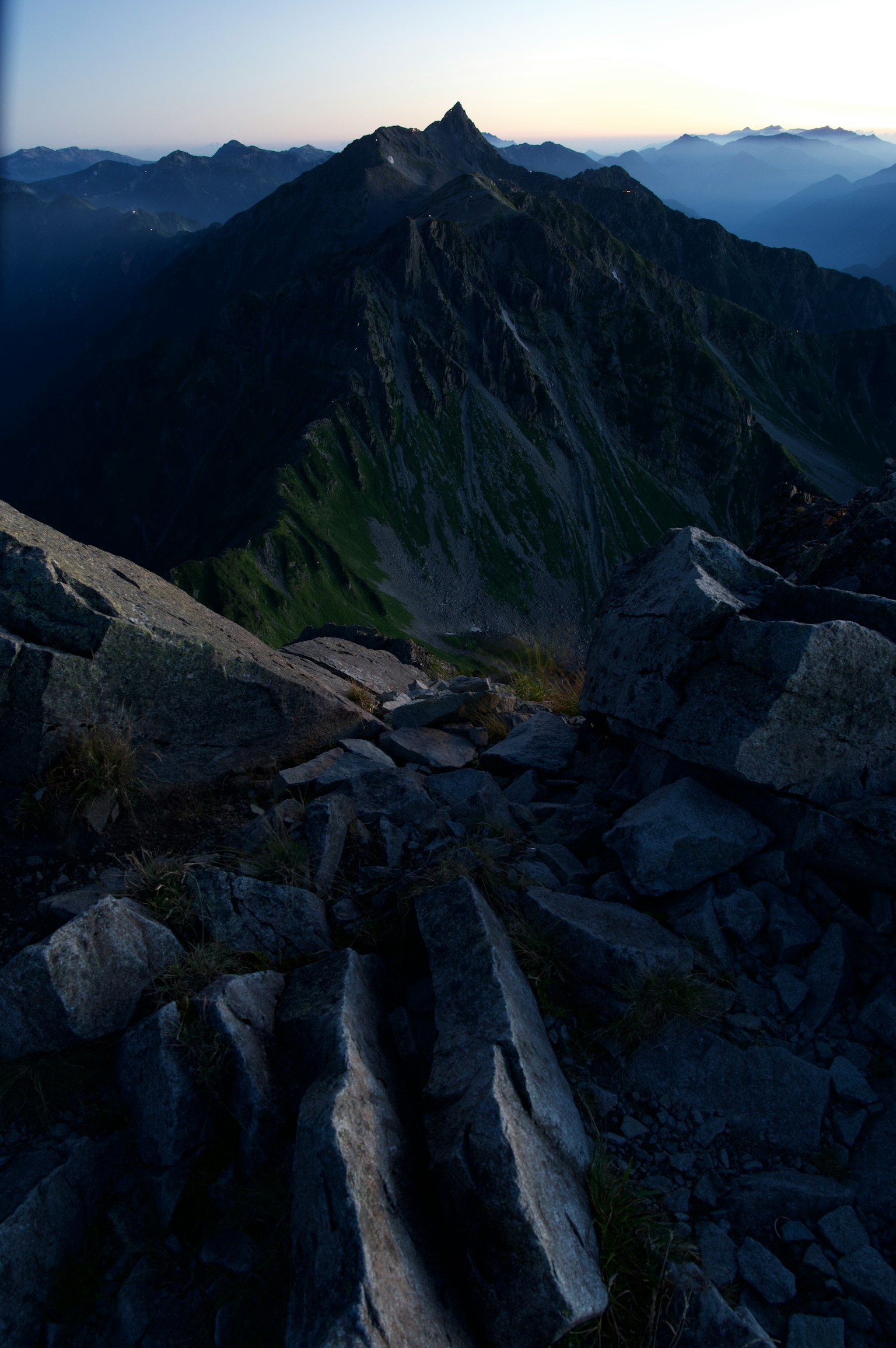 Mountain peak and rocky landscape at dusk with blue sky