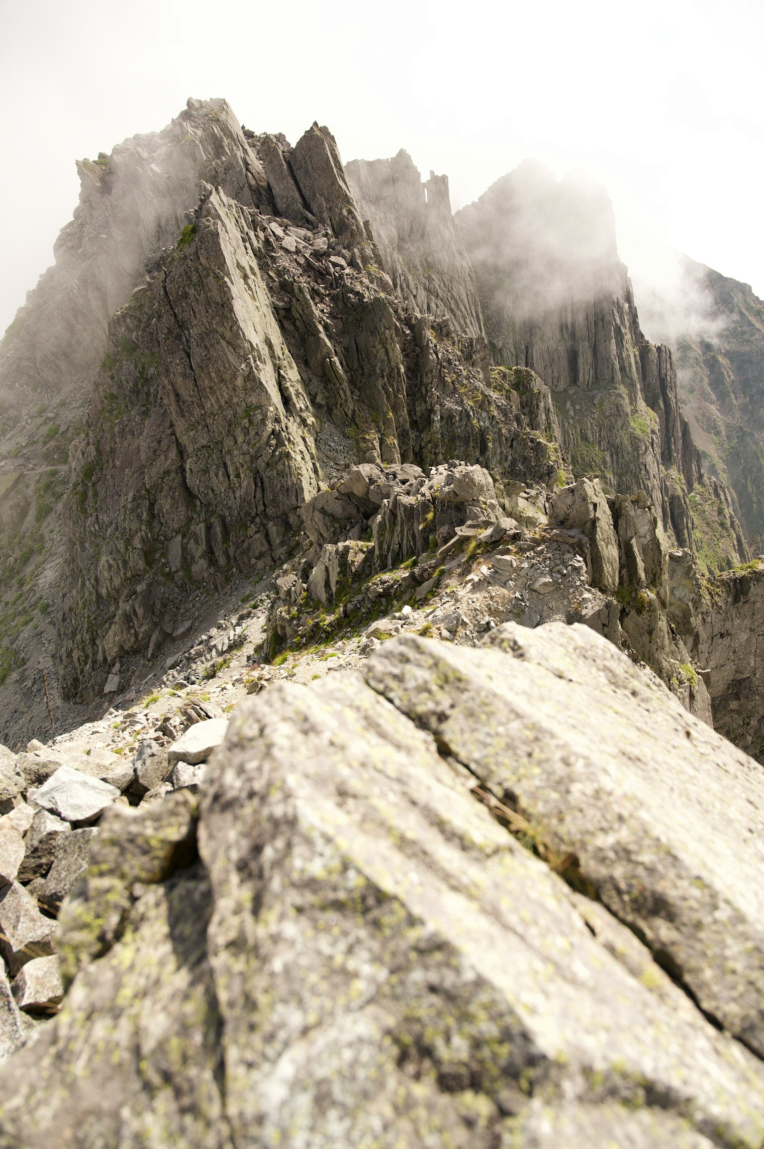 Foggy mountain peak with rocky terrain