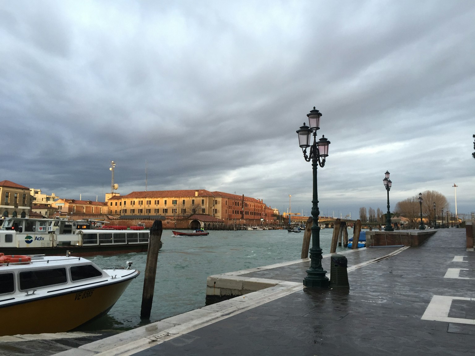 Calm canal water with historic buildings lining the shore