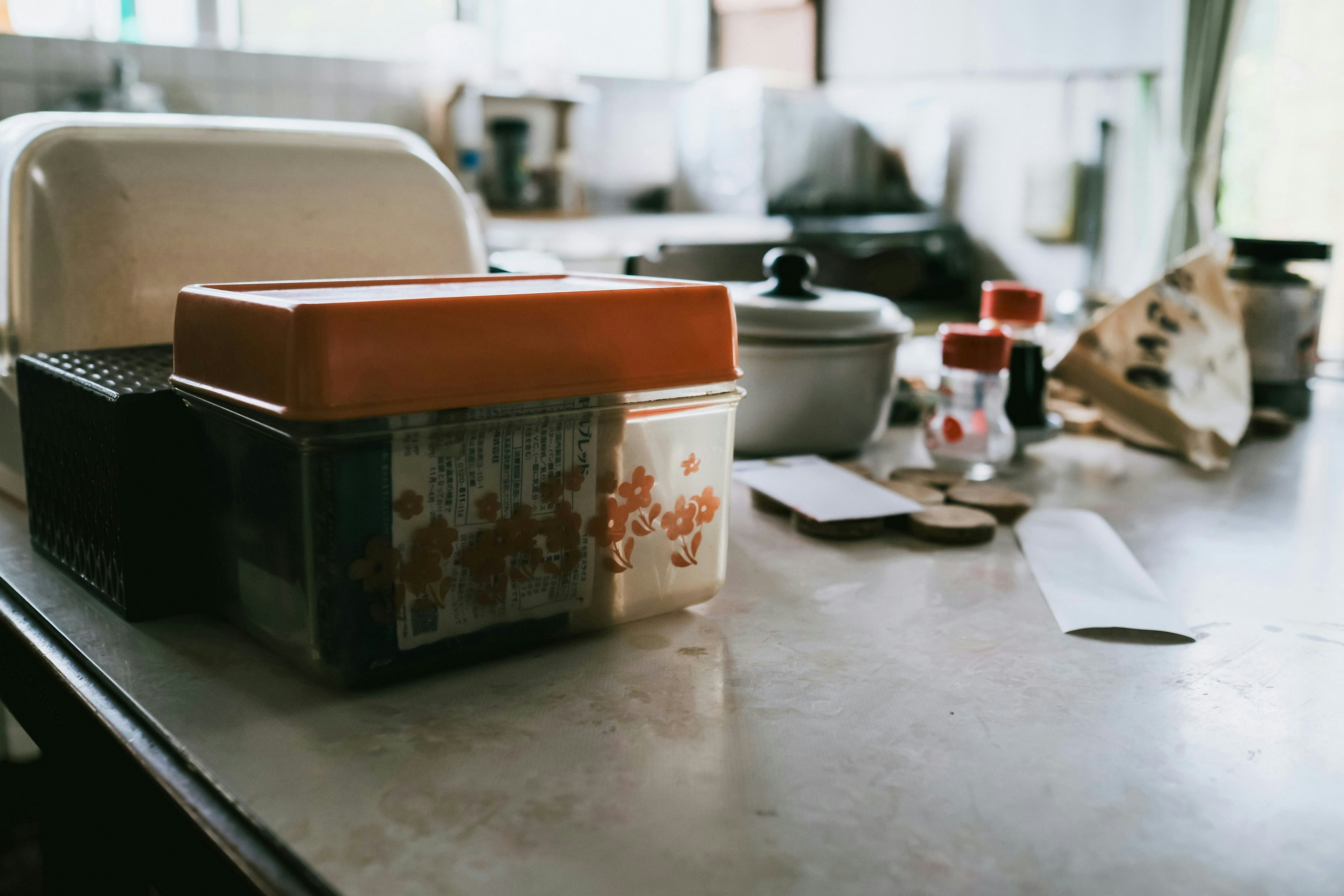 kitchen countertop with stacked dishes and storage containers