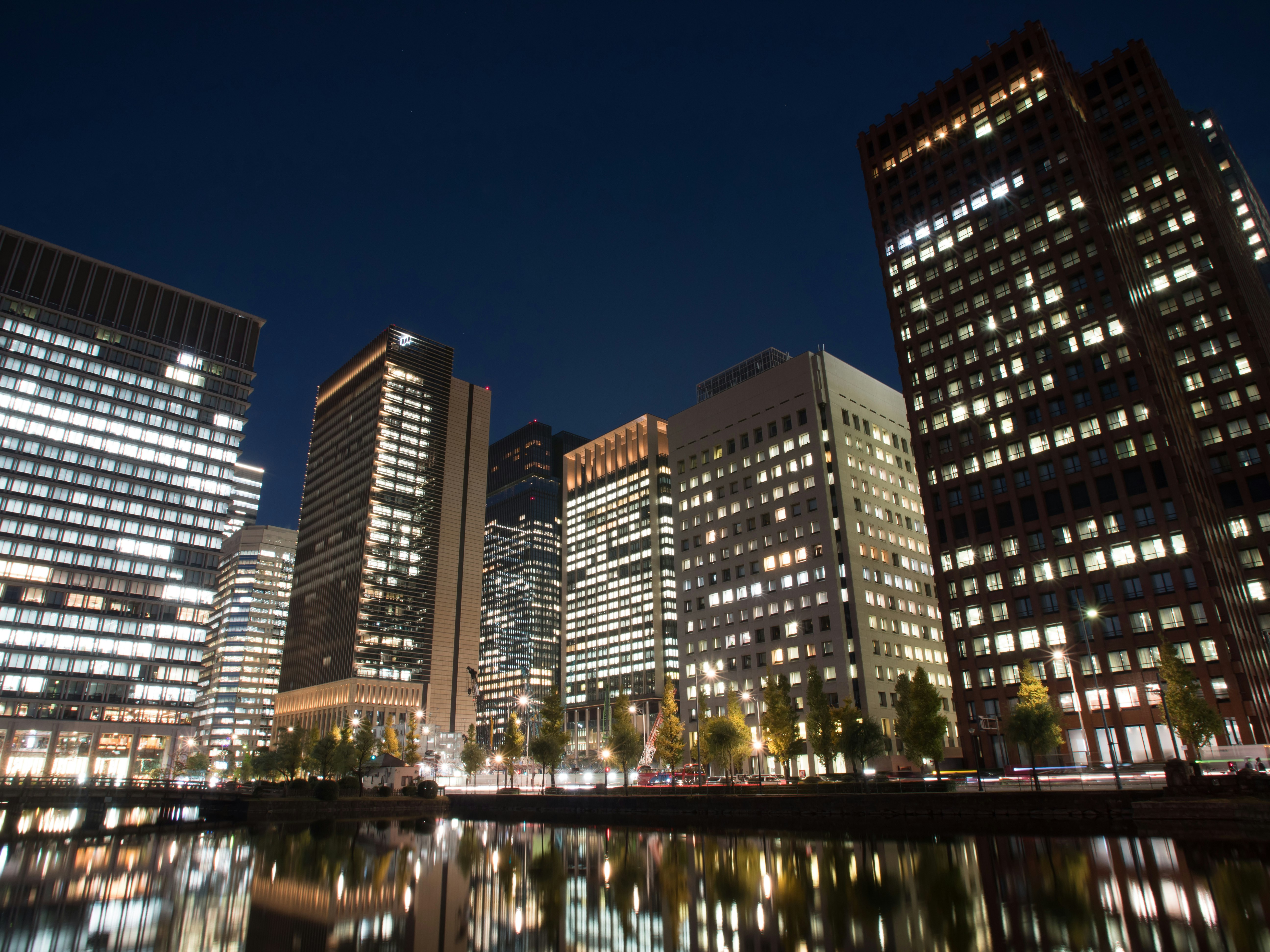 Marunouchi, Tokyo night skyline with high-rise buildings reflected on the river