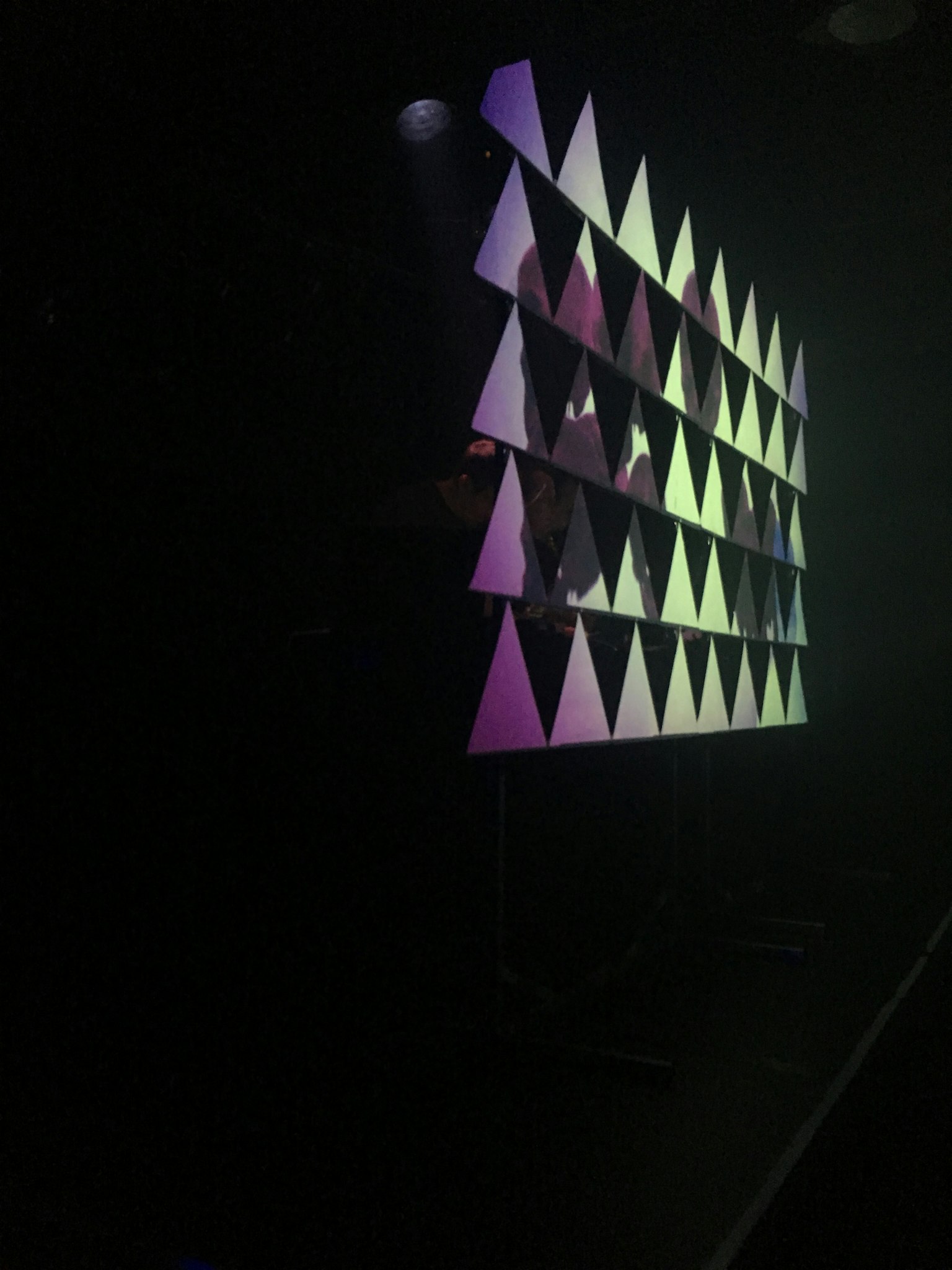 Image of a brightly lit triangular pattern display against a dark background