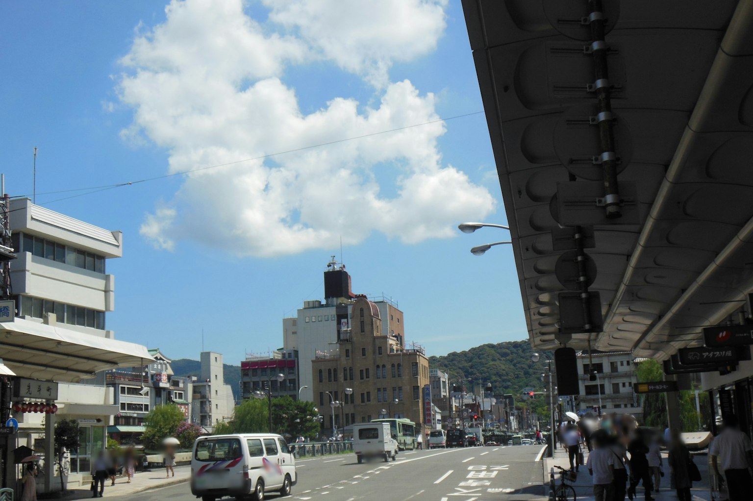 Urban scene with people and buildings under a blue sky