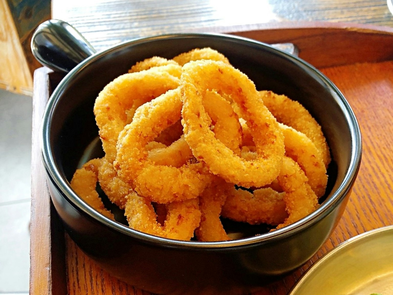 A bowl filled with crispy onion rings