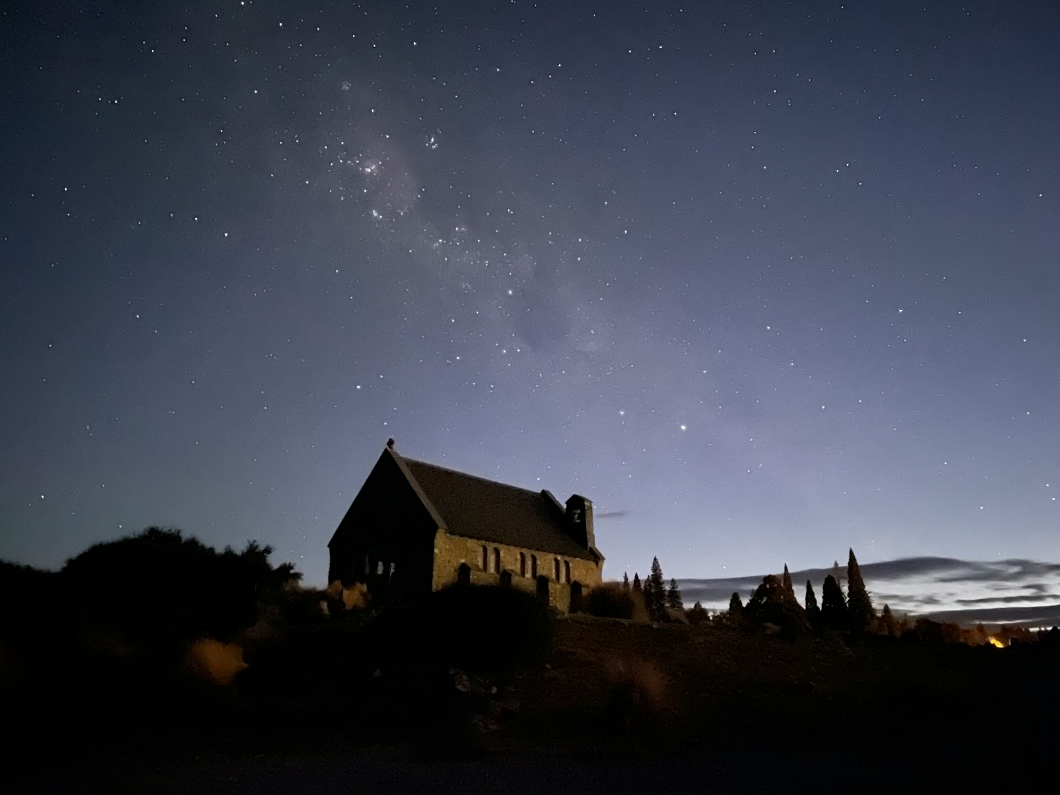 Silhouette of an old house under a starry sky