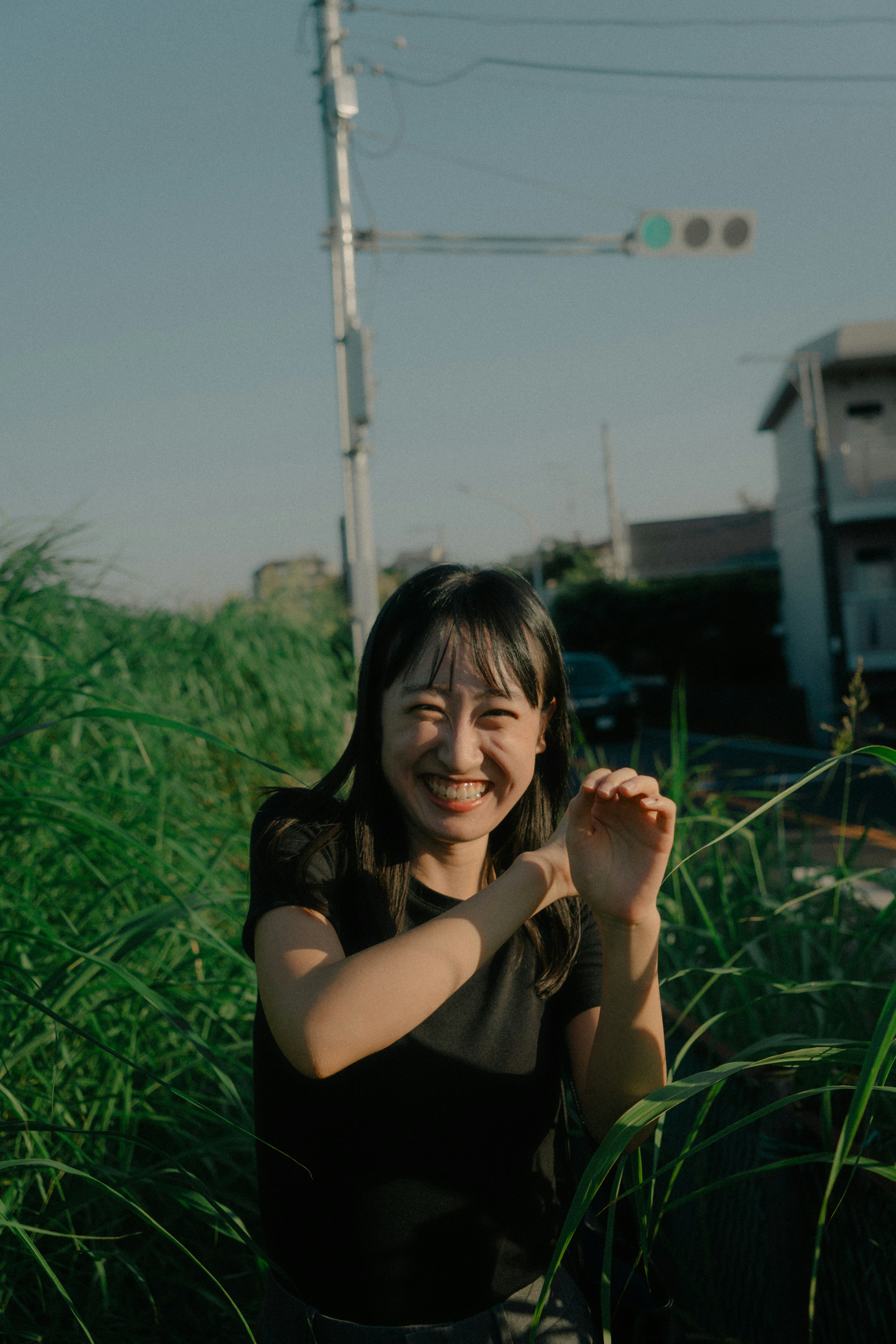草むらの中で笑顔の女性