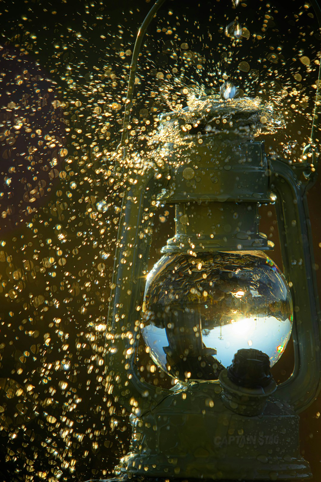 Golden light particles and spark-like effects inside a glass bottle image