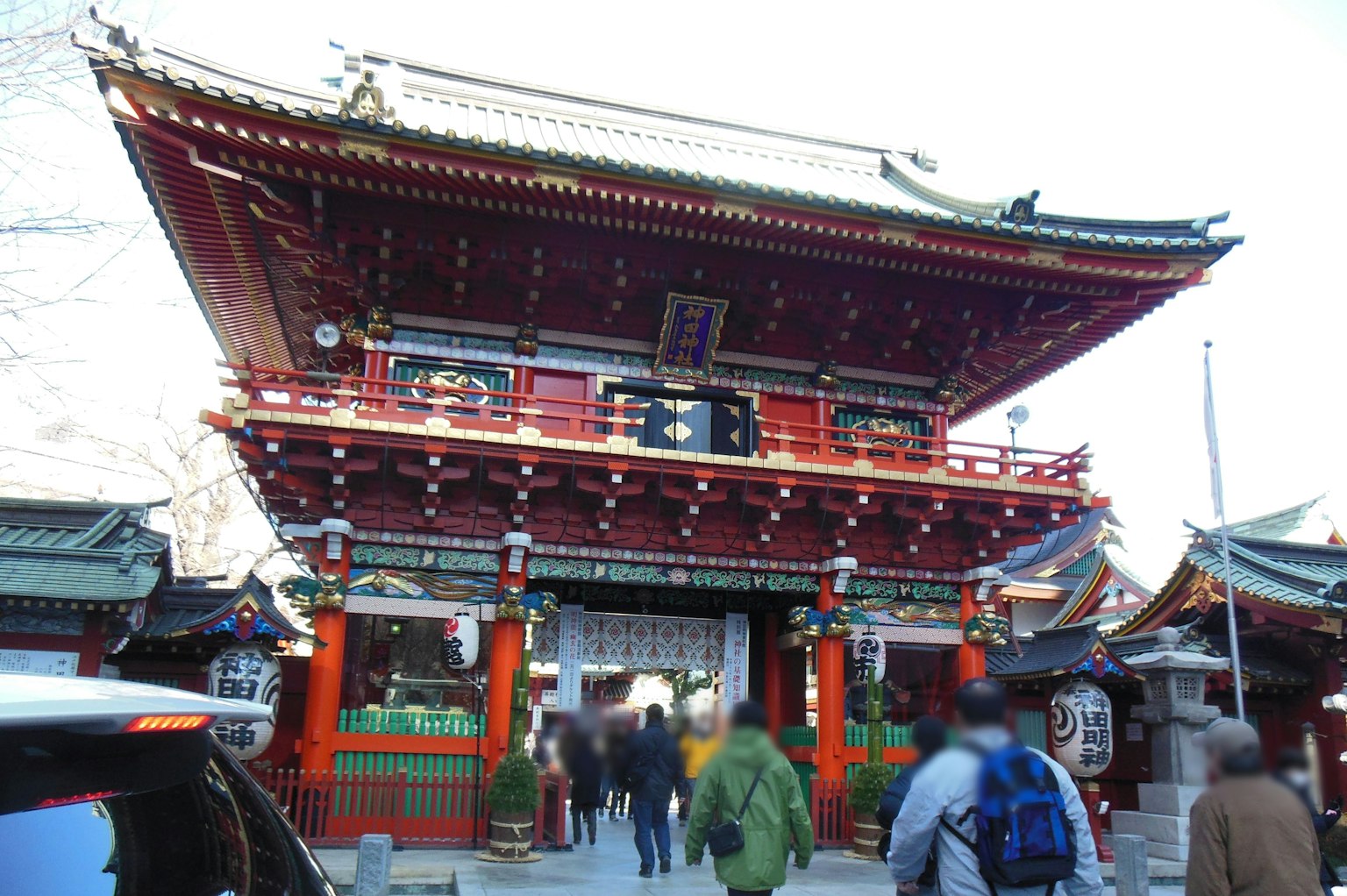 Traditional Japanese temple gate in red with a crowd of people