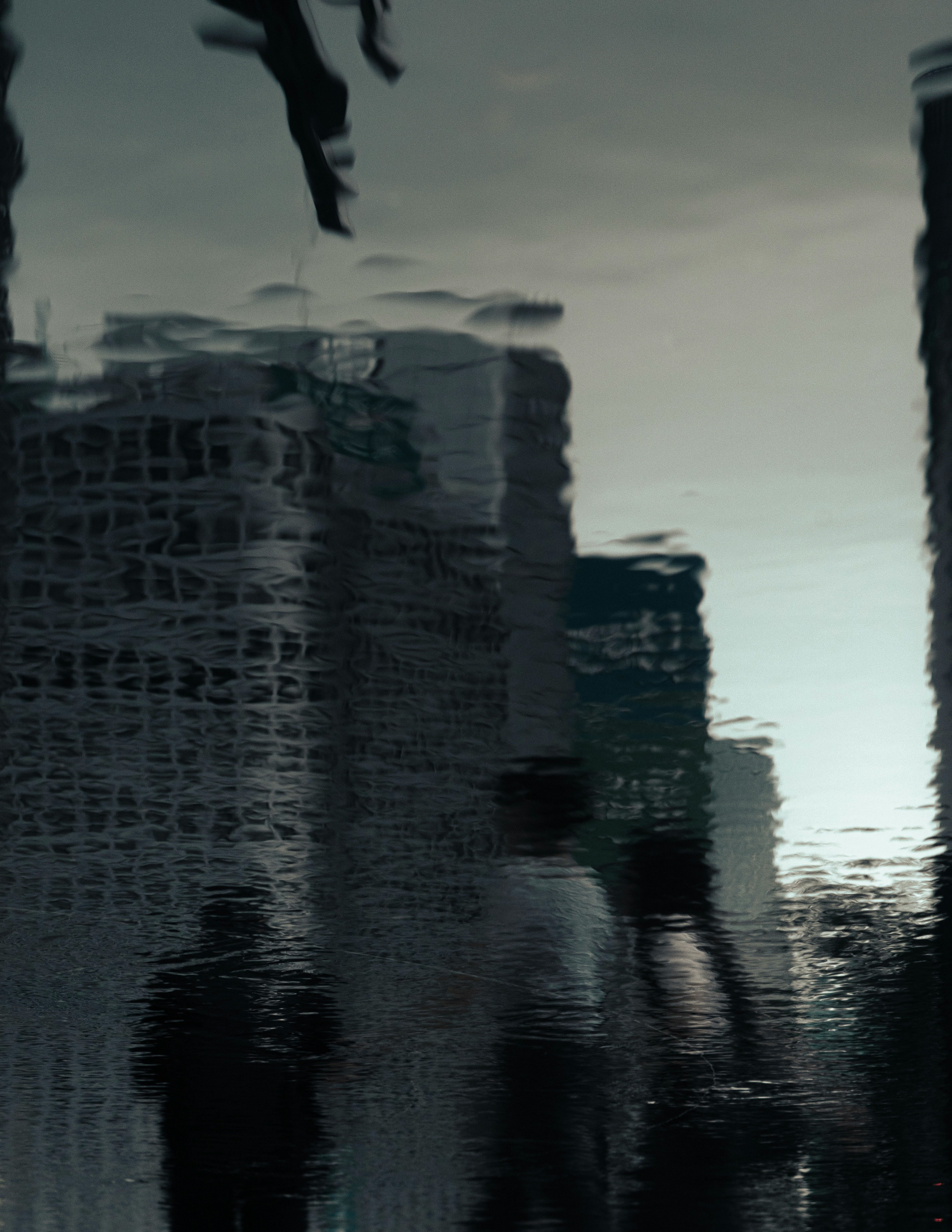 shoreline scene with stacked nets reflected on the water